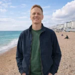 Dave King standing on Brighton beach