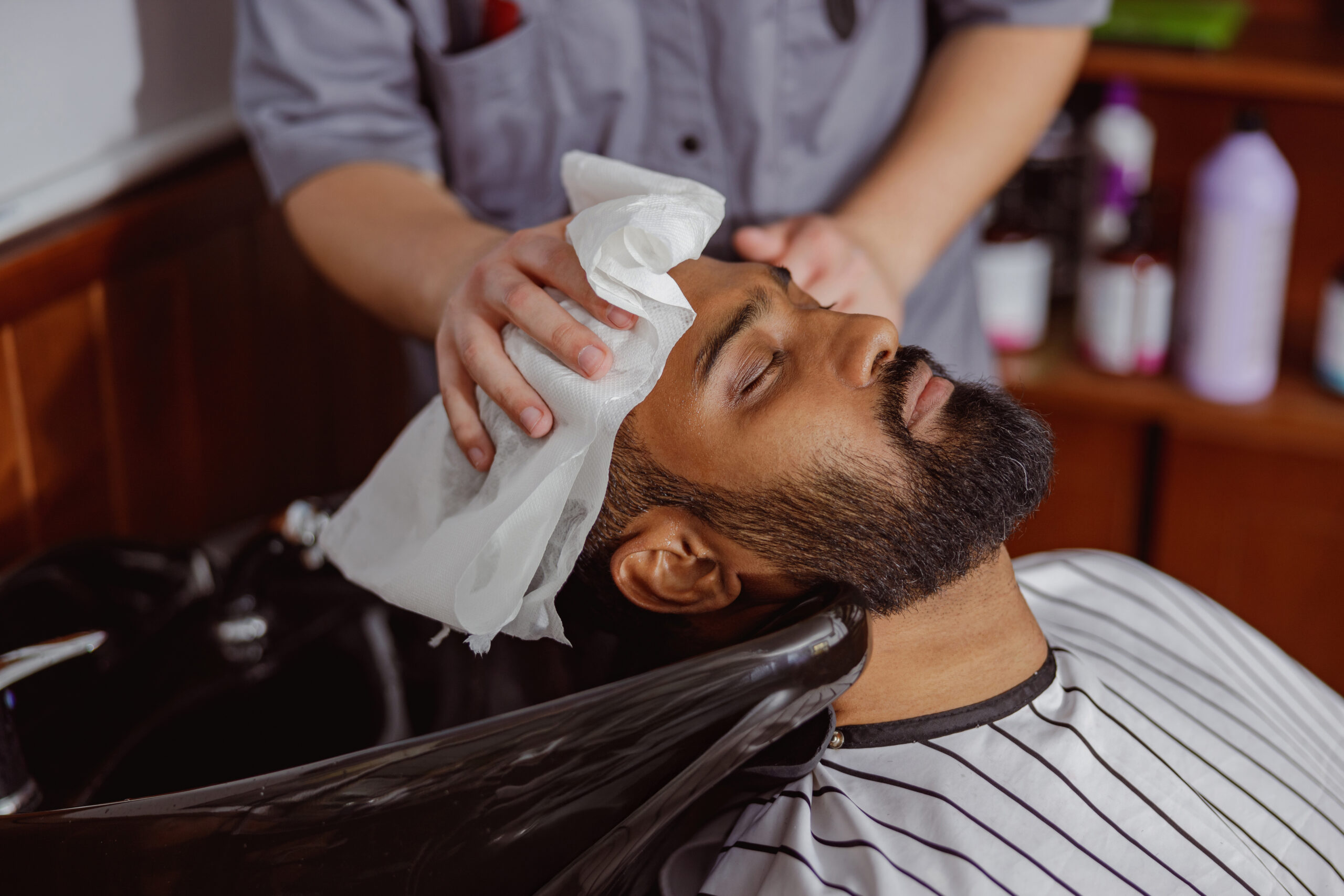 Barber Is Doing Haircut and giving hot towel treatment
