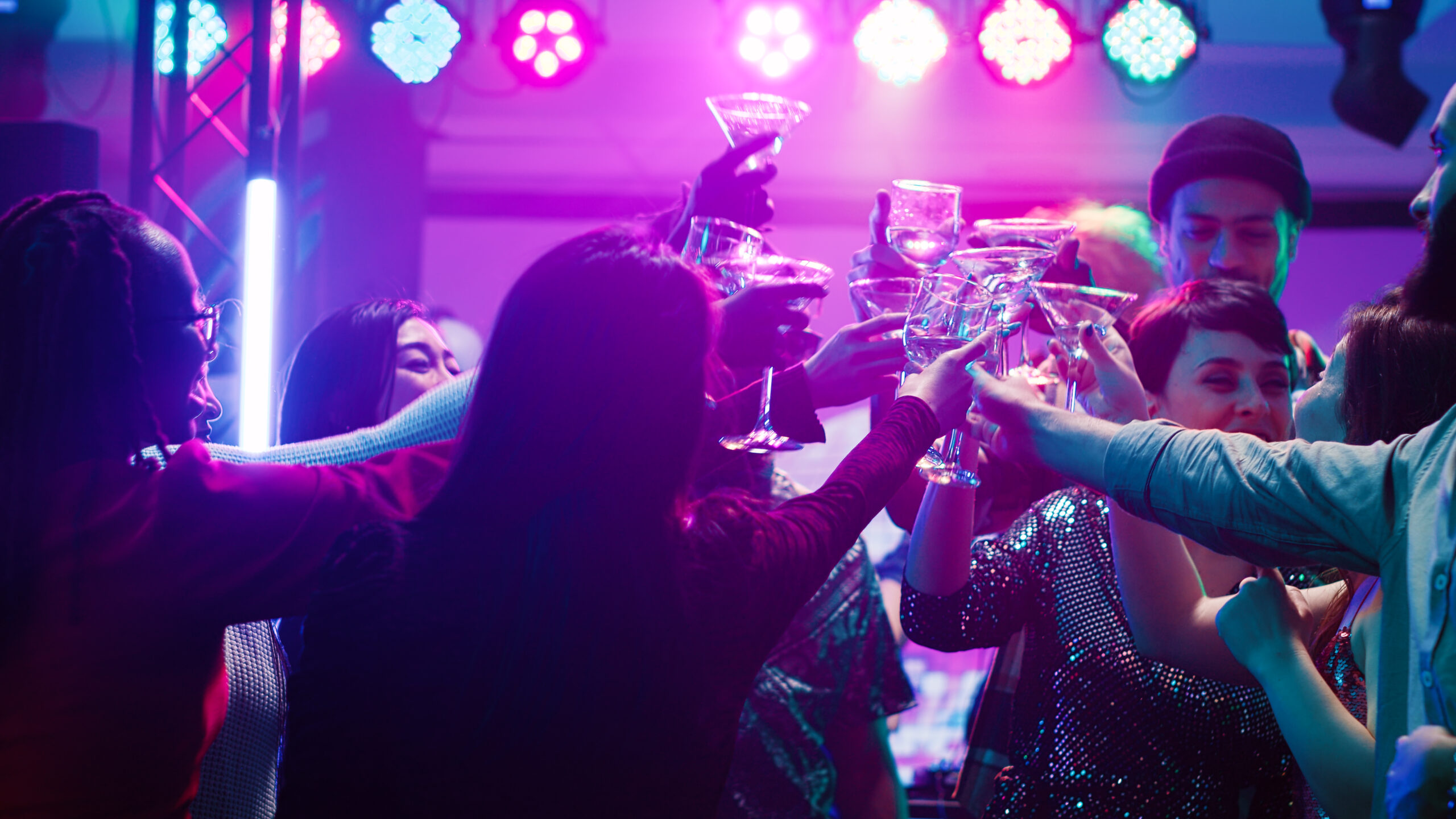 People Toasting Drinks Together at a nightclub
