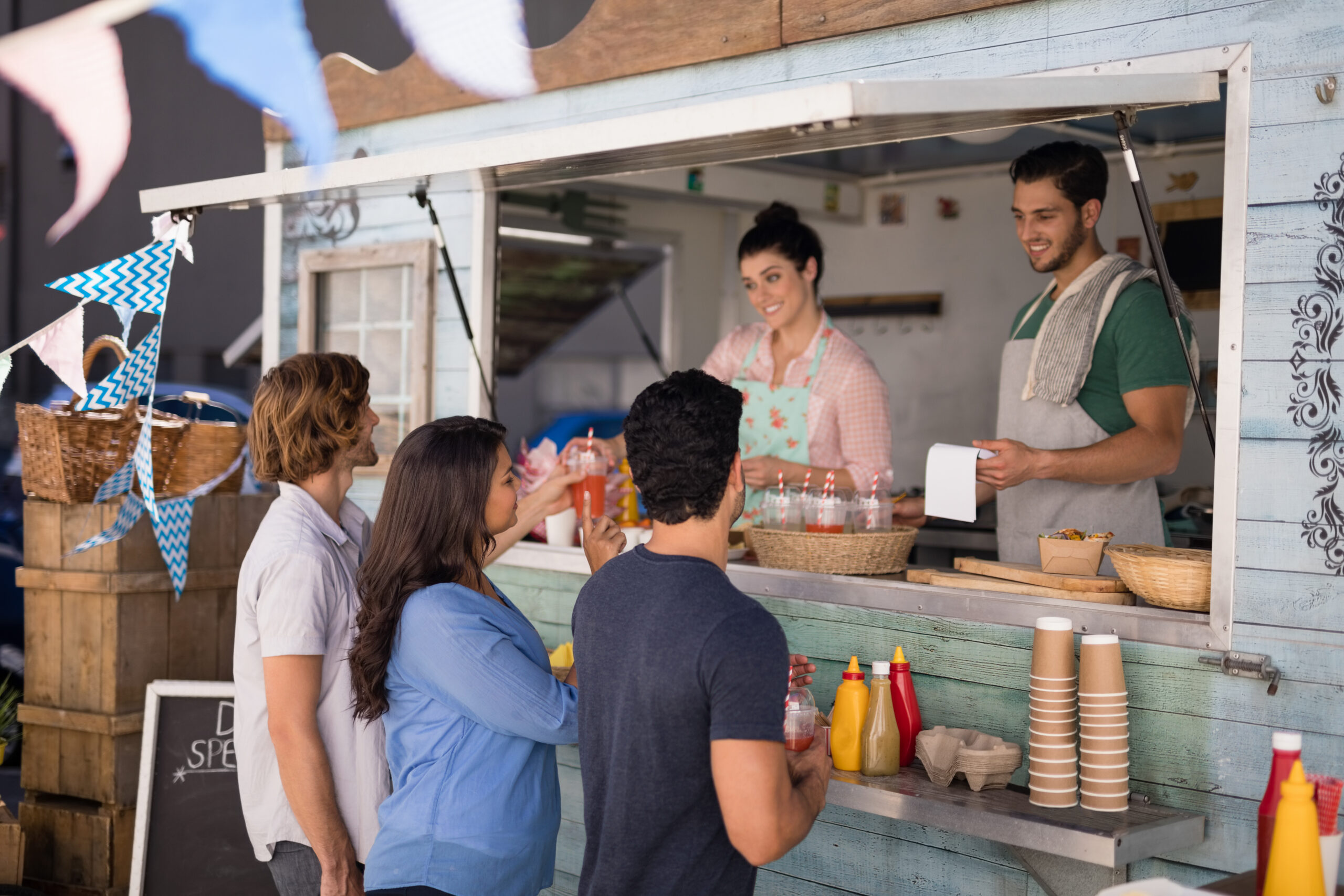 Cheap places to eat in Brighton- Smiling Waiter Taking Order From Customer