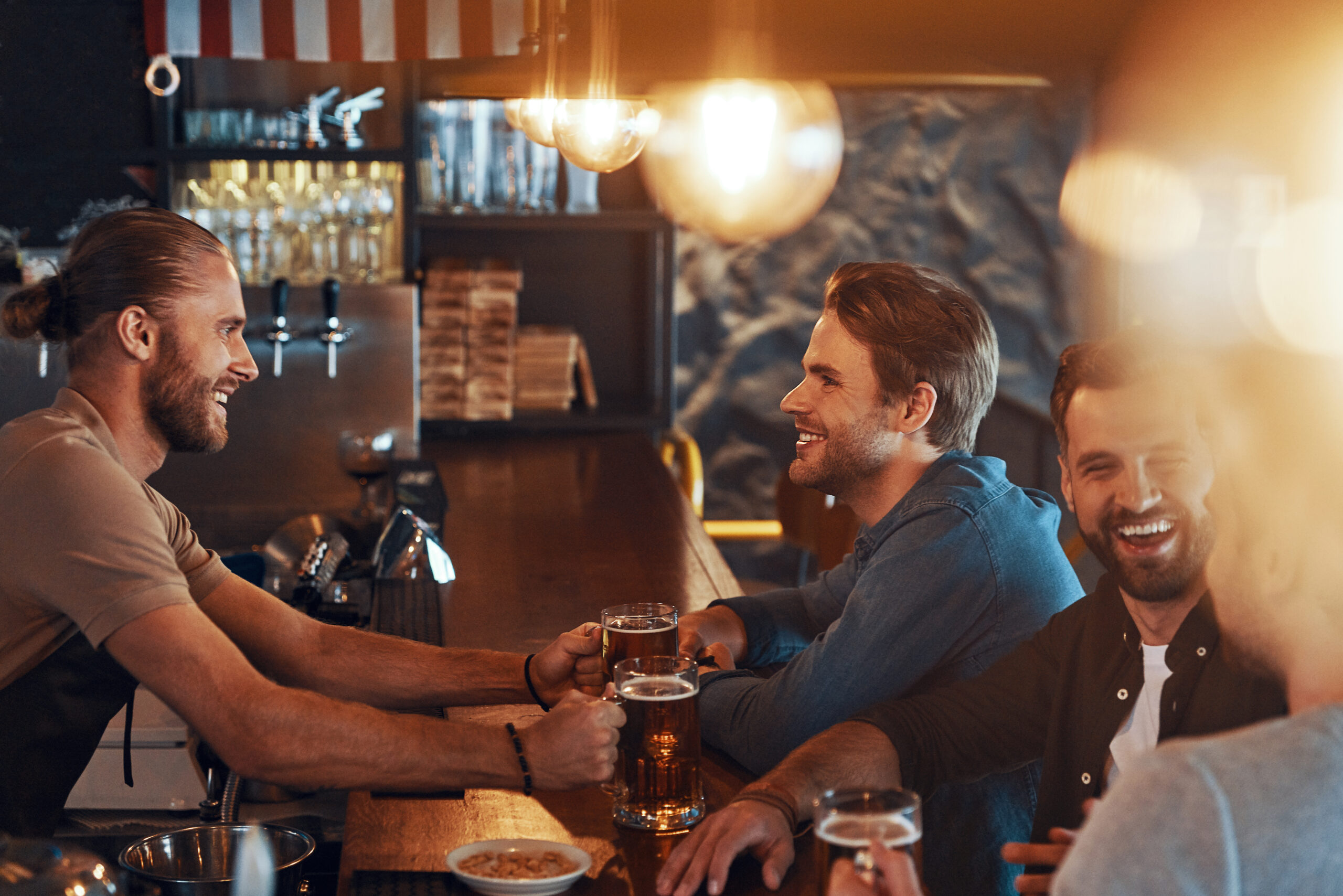A barman serving beer to a happy man