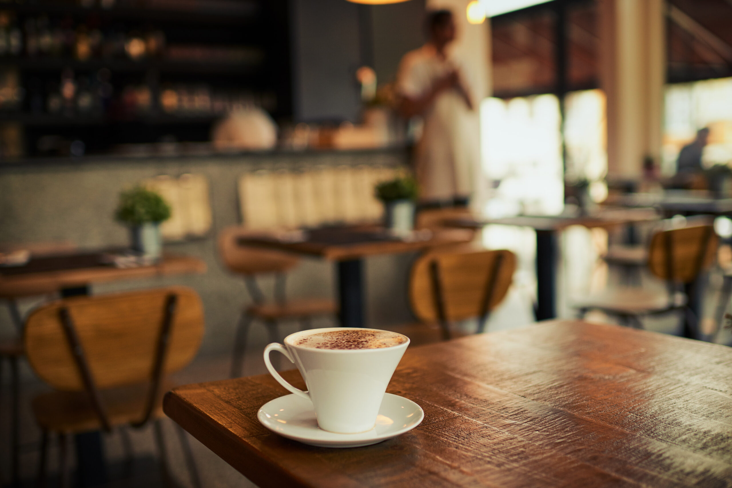 Coffee Cup On Table In Cafe Interior at one of the best cafes in Brighton