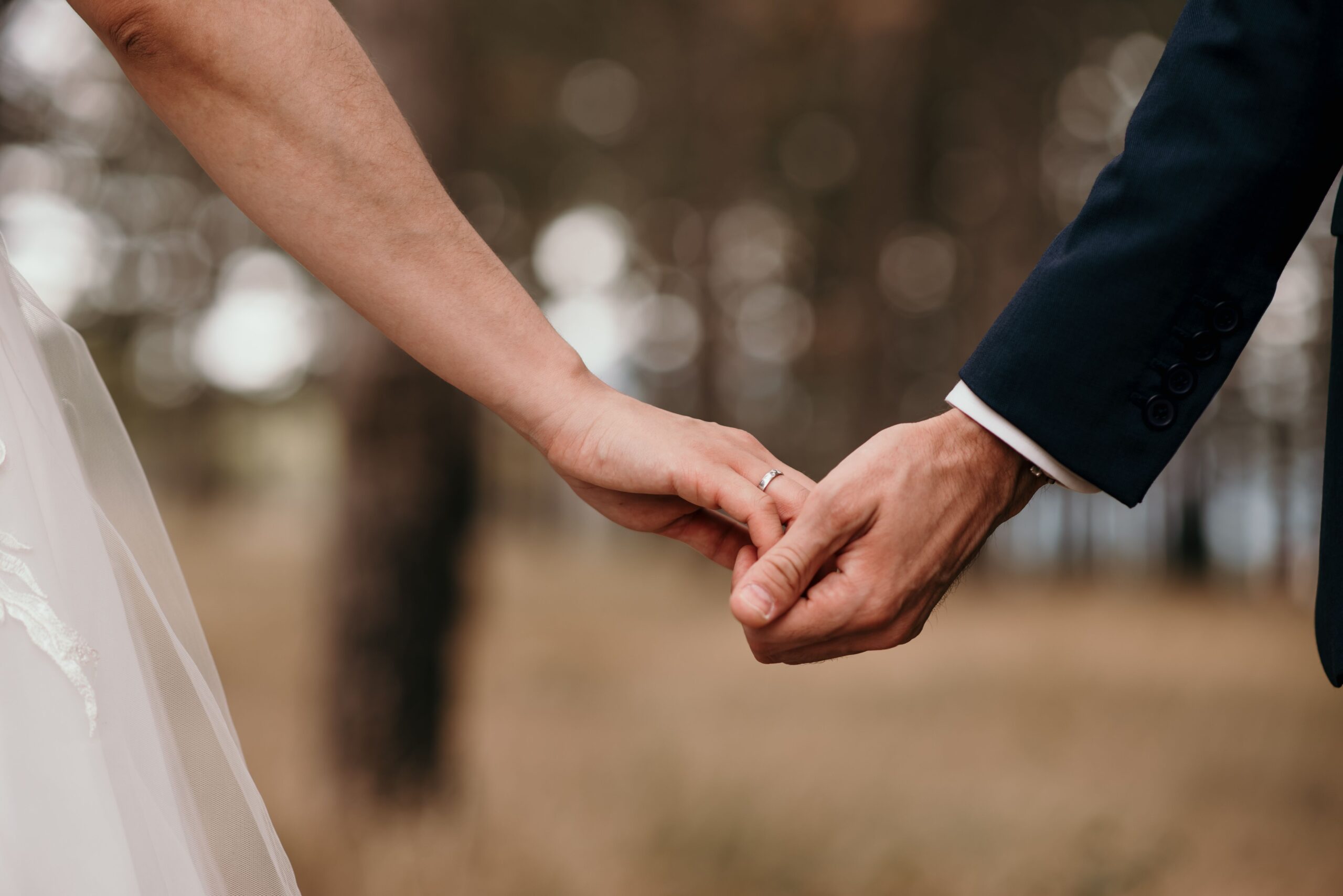 Couple Holding Hands At Wedding