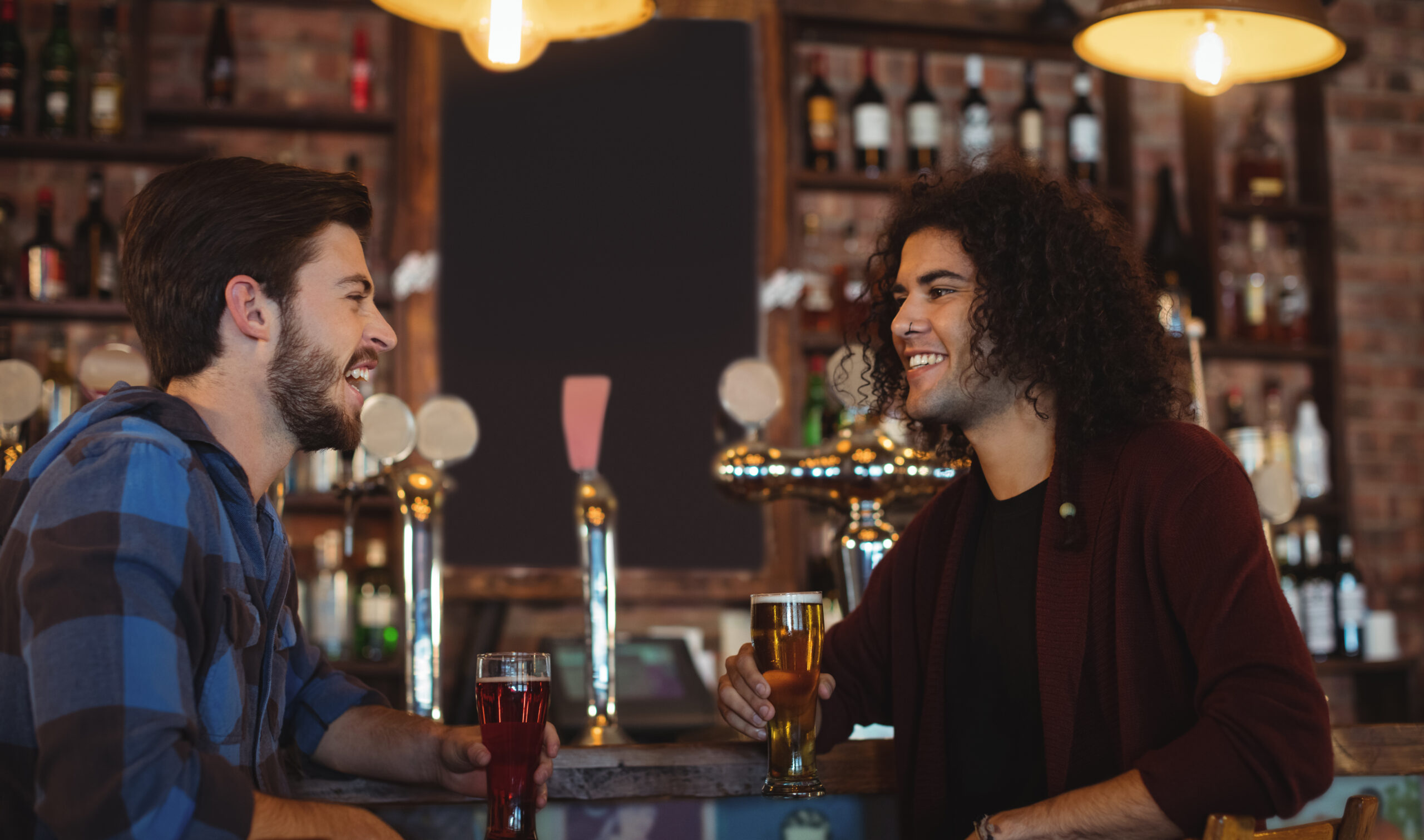 2 men having a drink at a bar