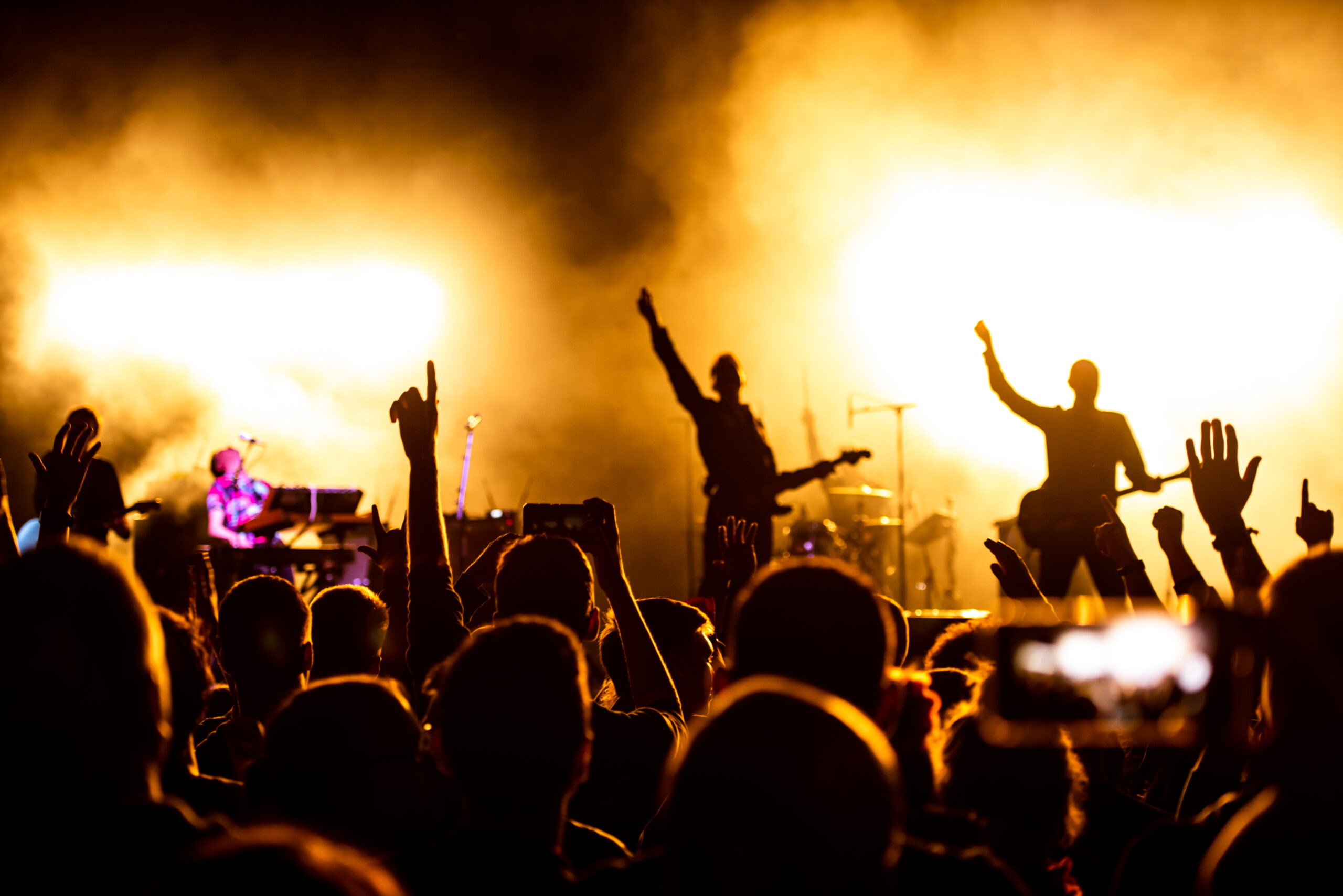A band performs on a smoky stage 