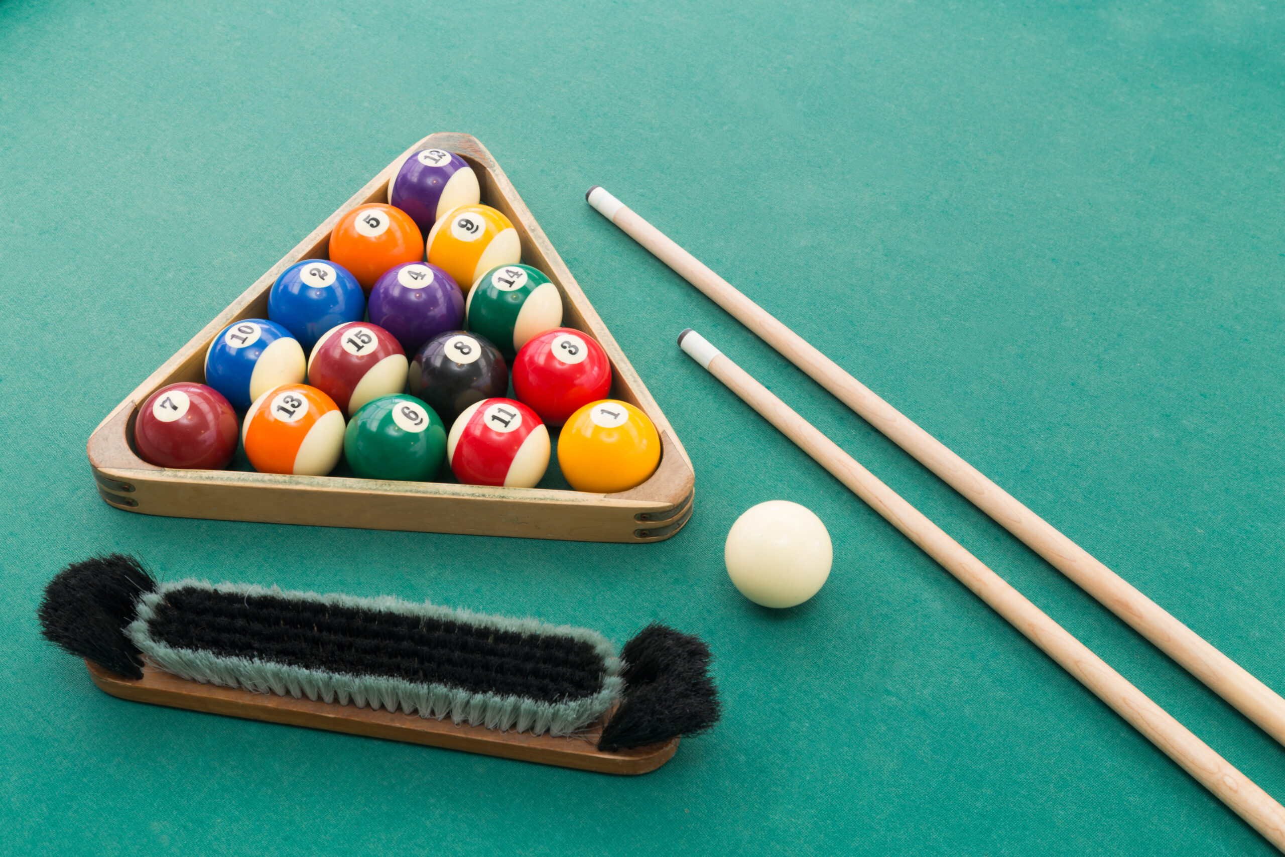 Pool Balls, a Cue, a Brush and Chalk On a pool table ready to play pool in Brighton