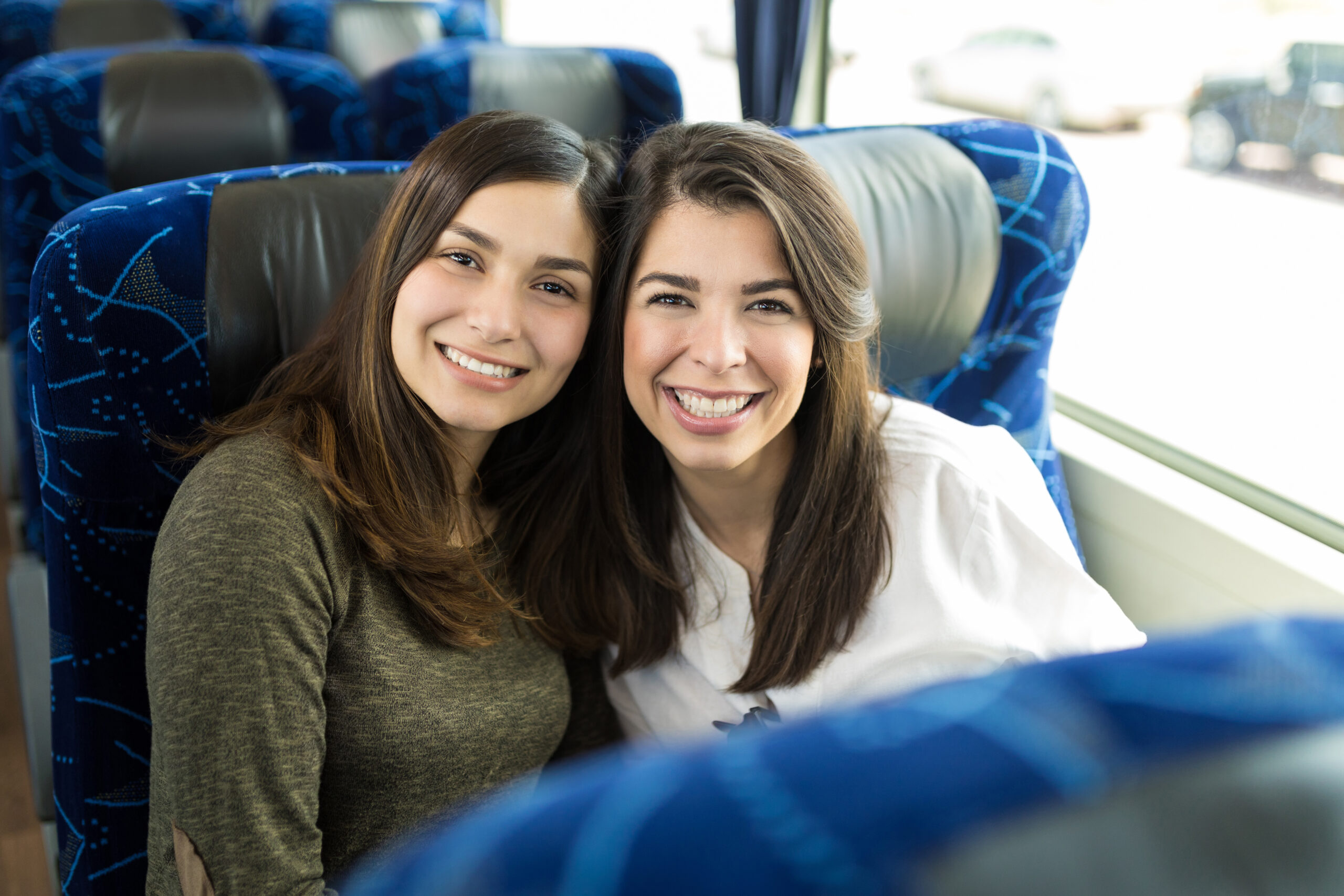 Smiling Women Posing On A Coach going from Gatwick to Brighton