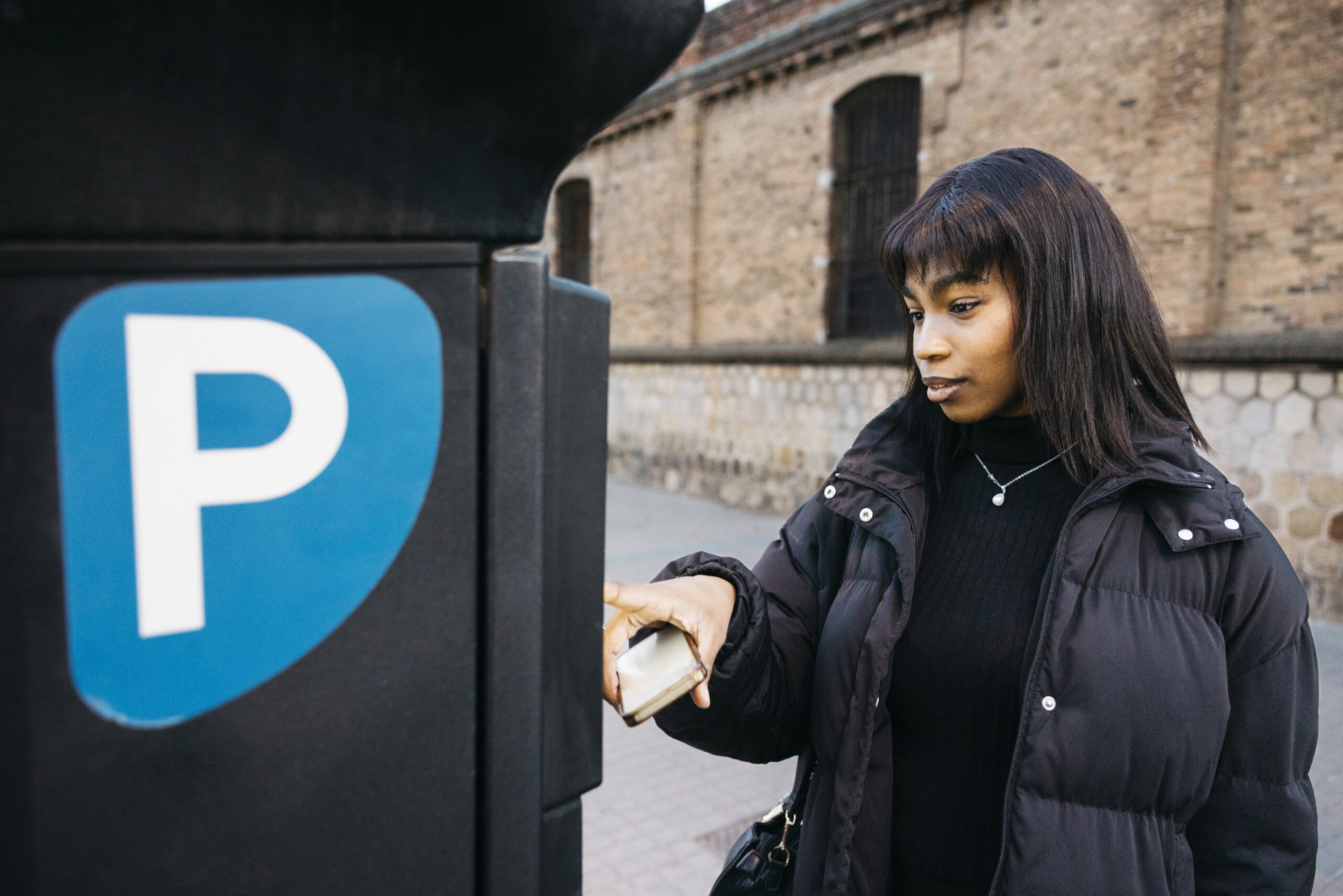Woman Using Parking Payment Machine Outdoors 