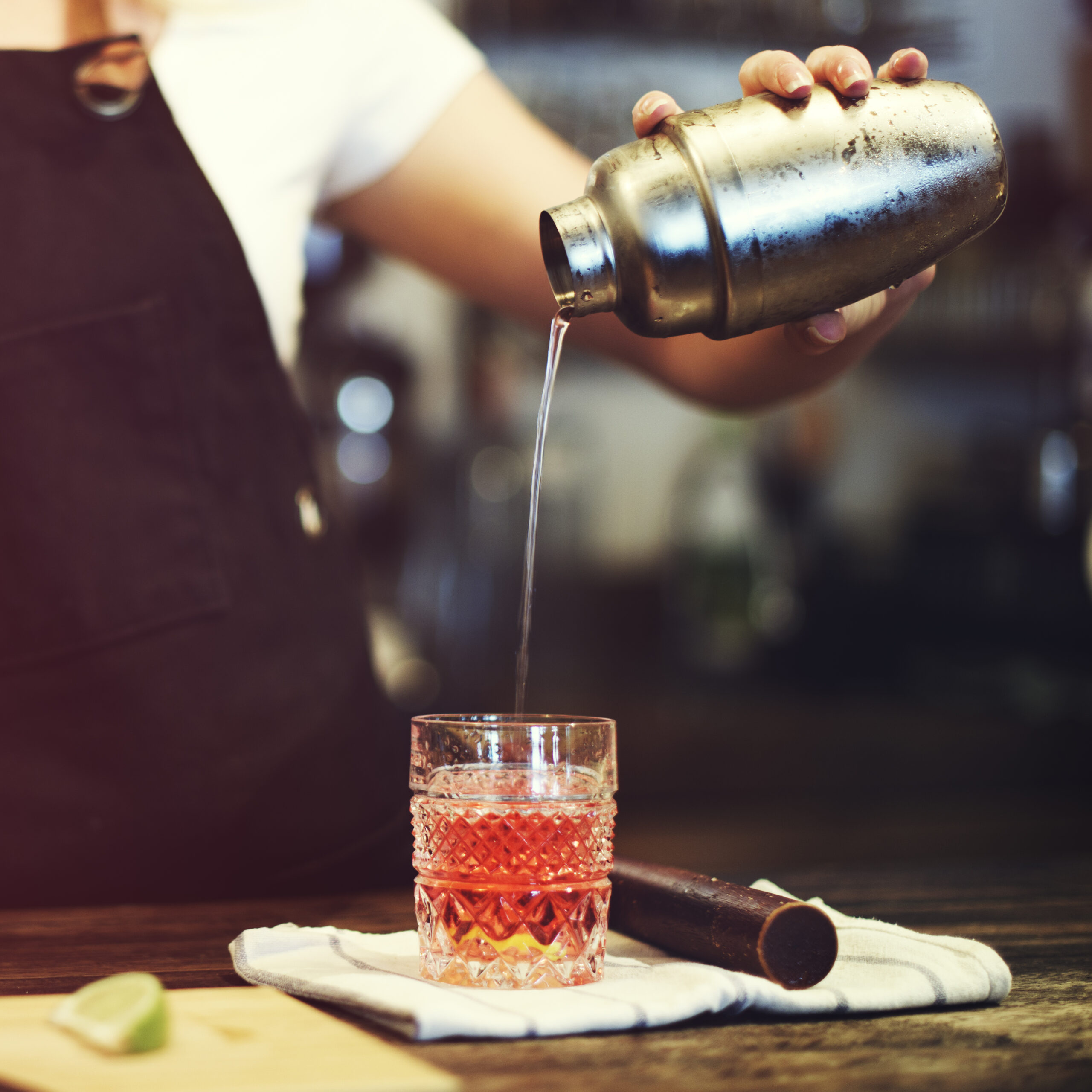 A bartender making a cocktail at one of the cocktail bars in Brighton