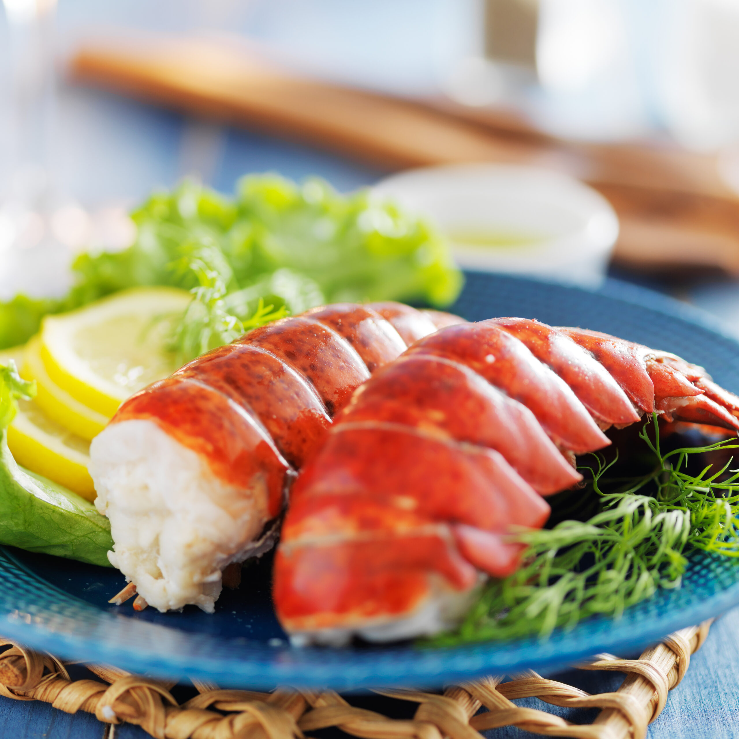 Lobster Tails on Plate with Lemon and Lettuce at one of the seafood restaurants in Brighton
