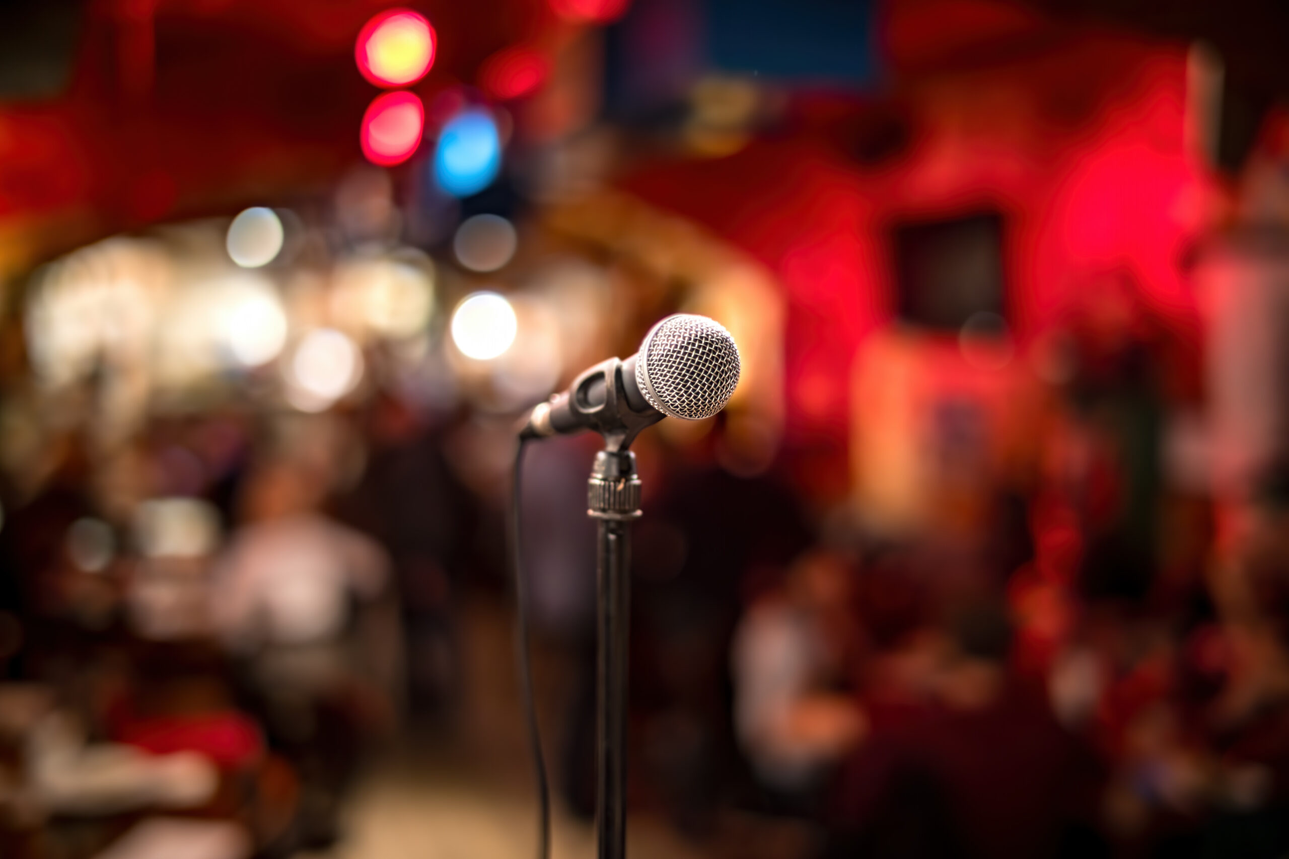 Public performance on stage Microphone on stage against a background of auditorium. Shallow depth of field.
