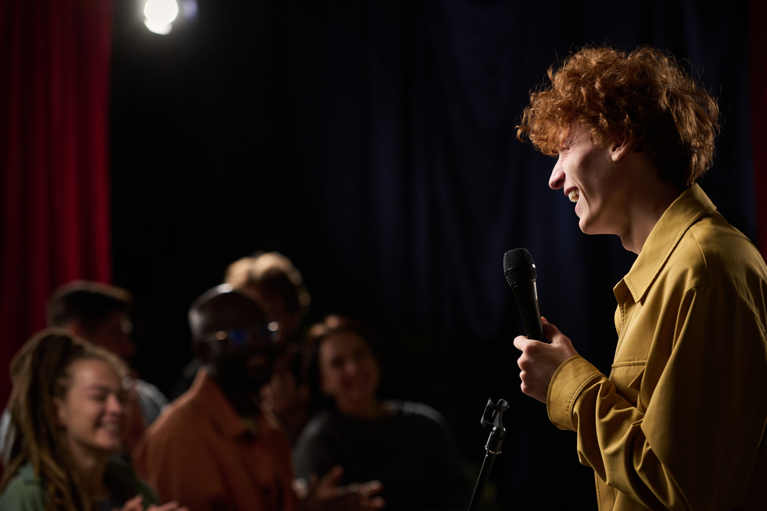 A man performing Stand Up Comedy In Front Of an Audience