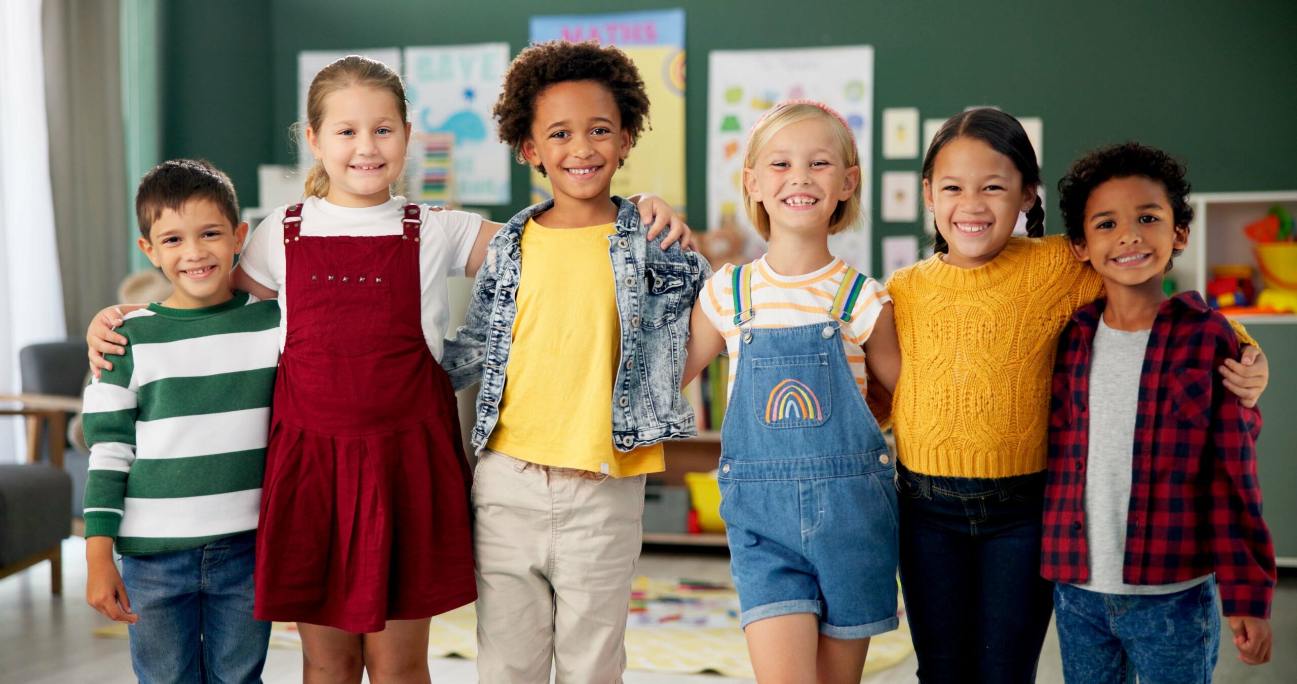Smiling Children Standing Together In a Classroom