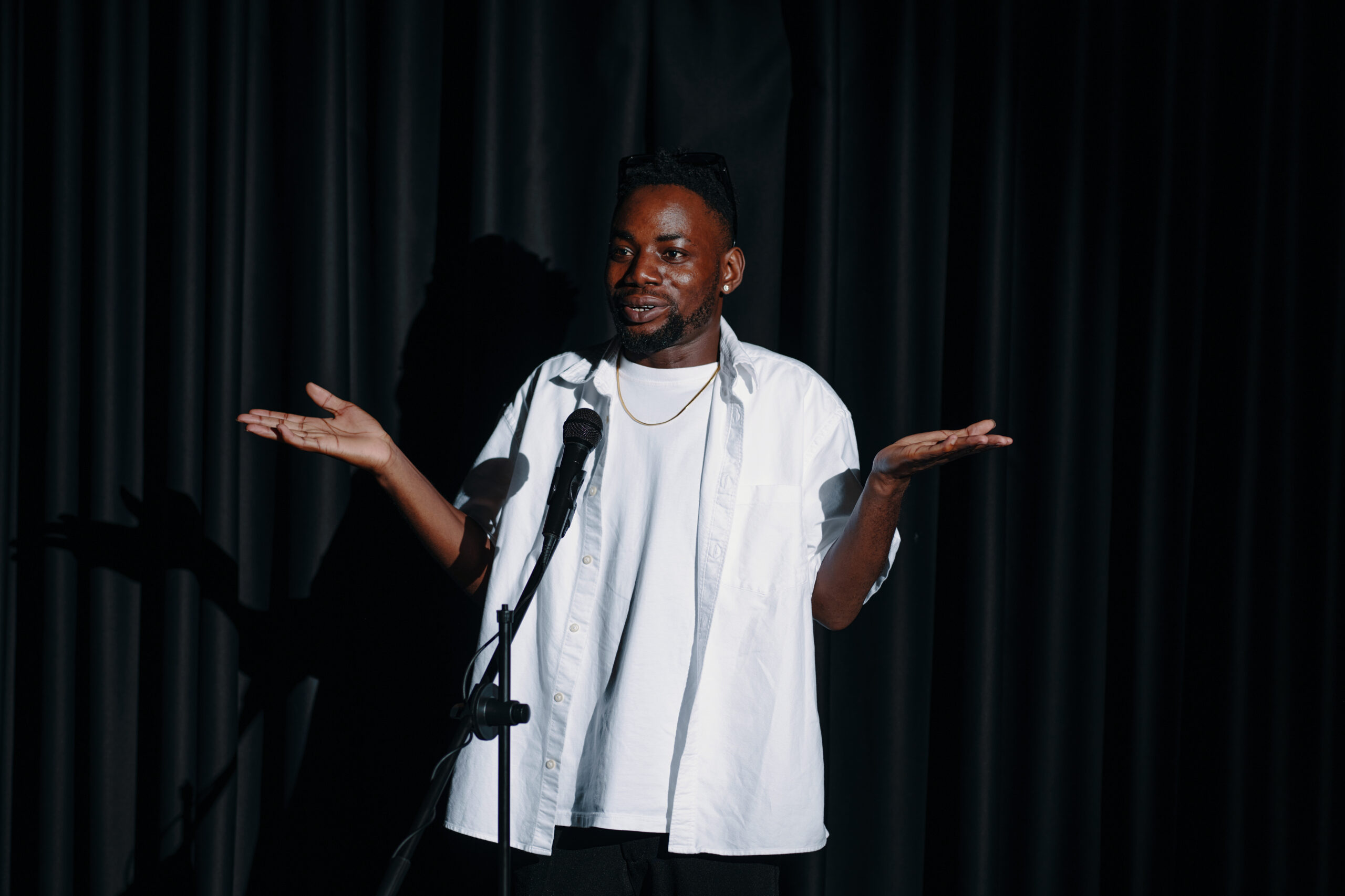 Smiling Man Giving Stand Up Comedy Performance