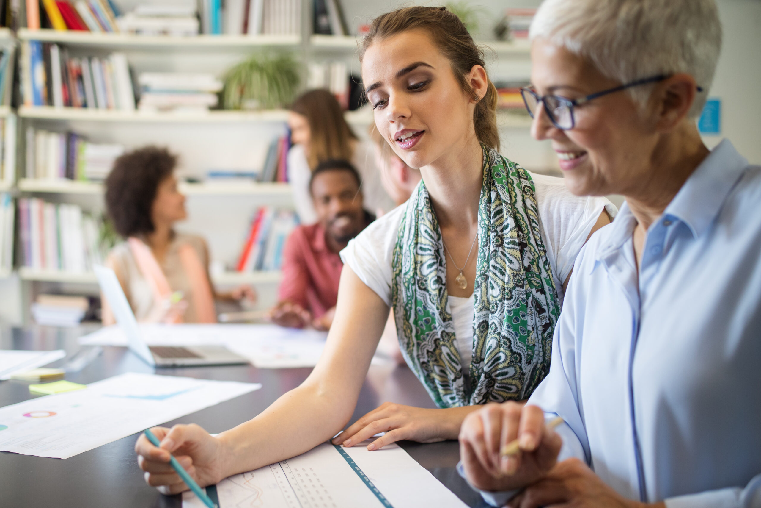 Young woman teaching senior woman 