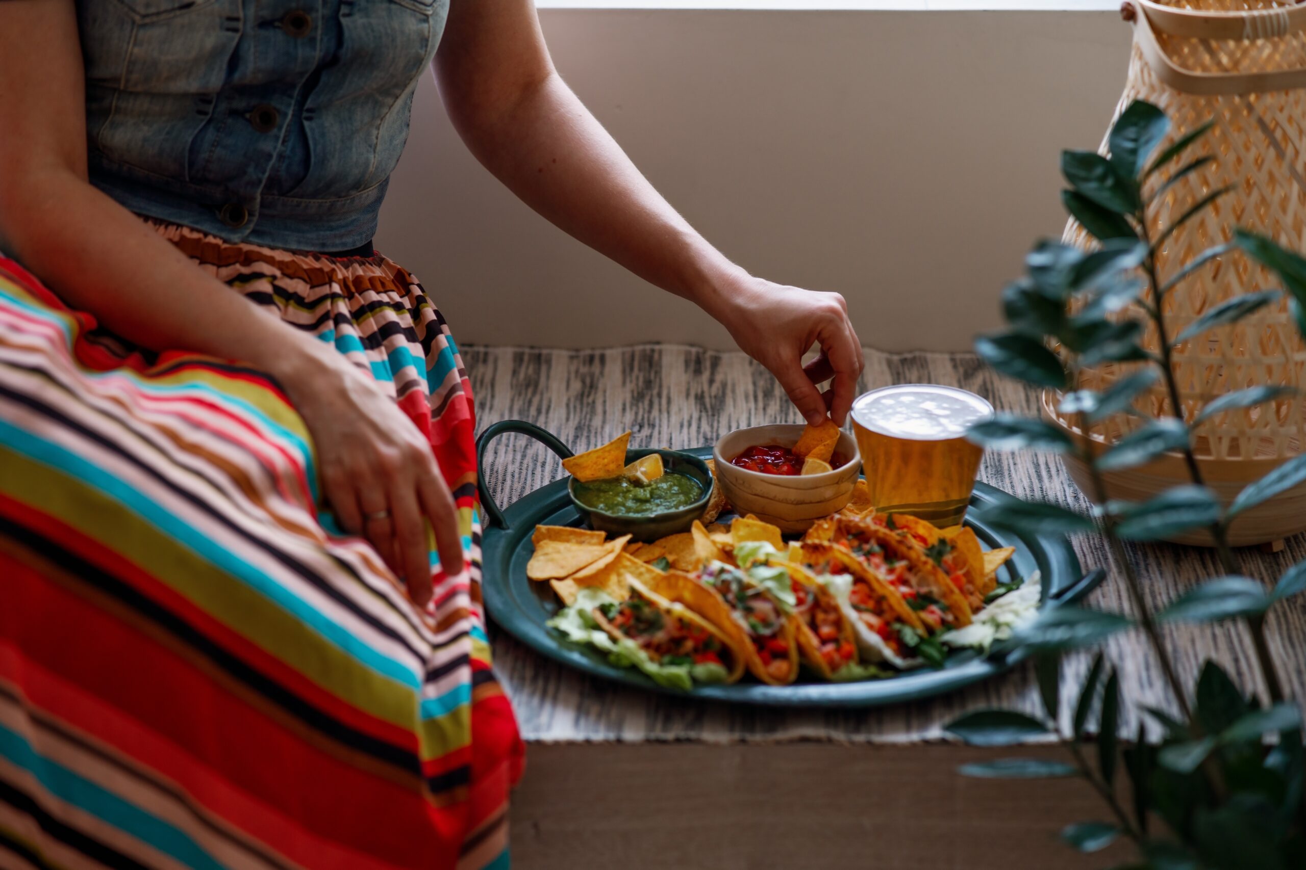 A woman eating Mexican food at home