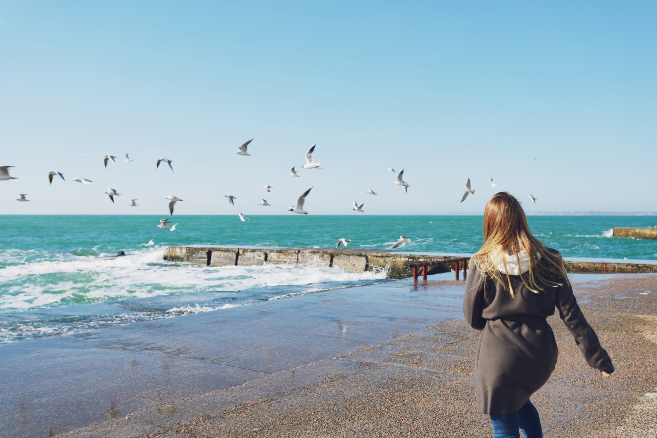 Carefree Woman Running On The Beach