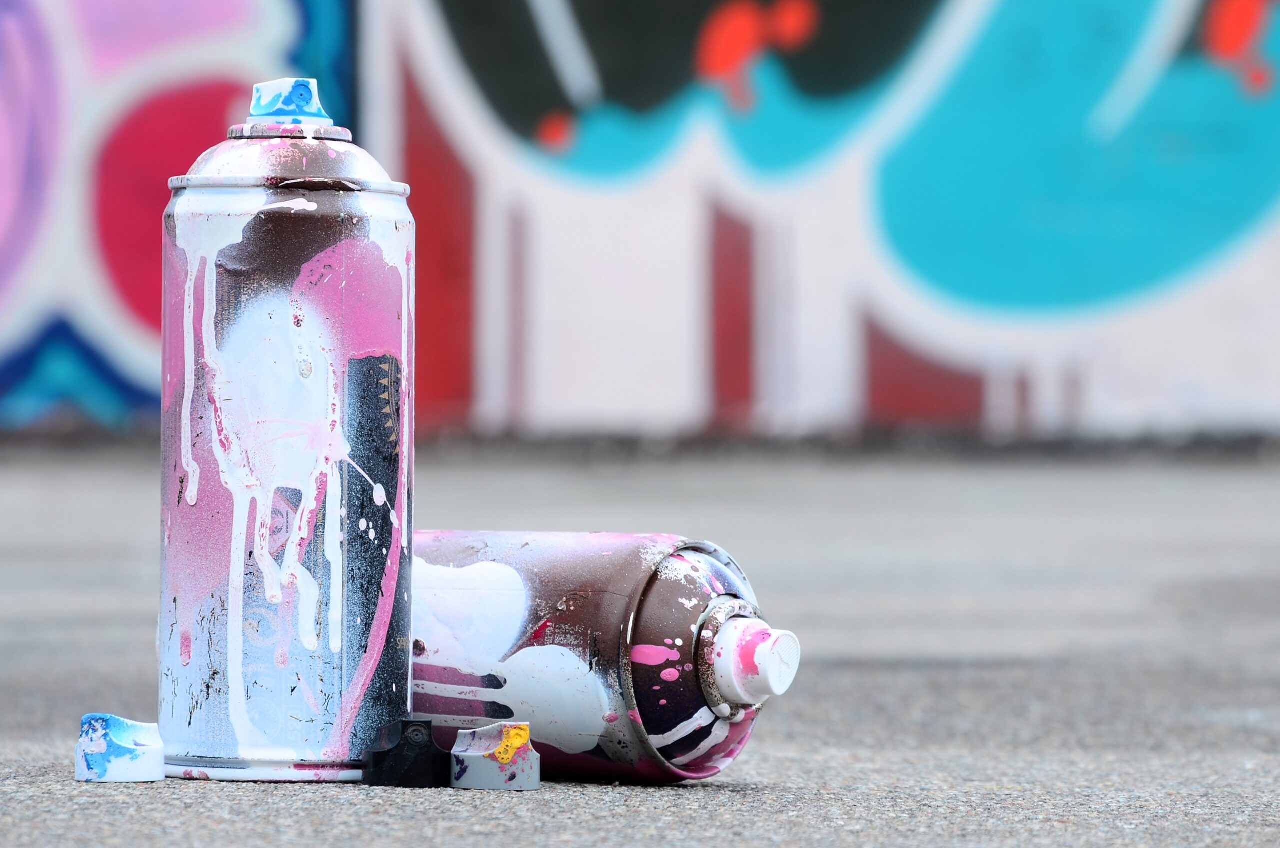 2 used spray cans with pink and white paint