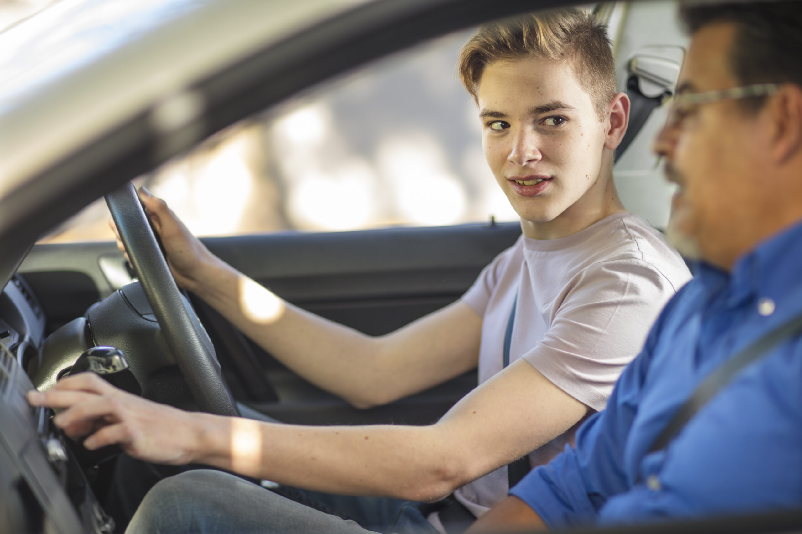Learner driver with instructor in a car