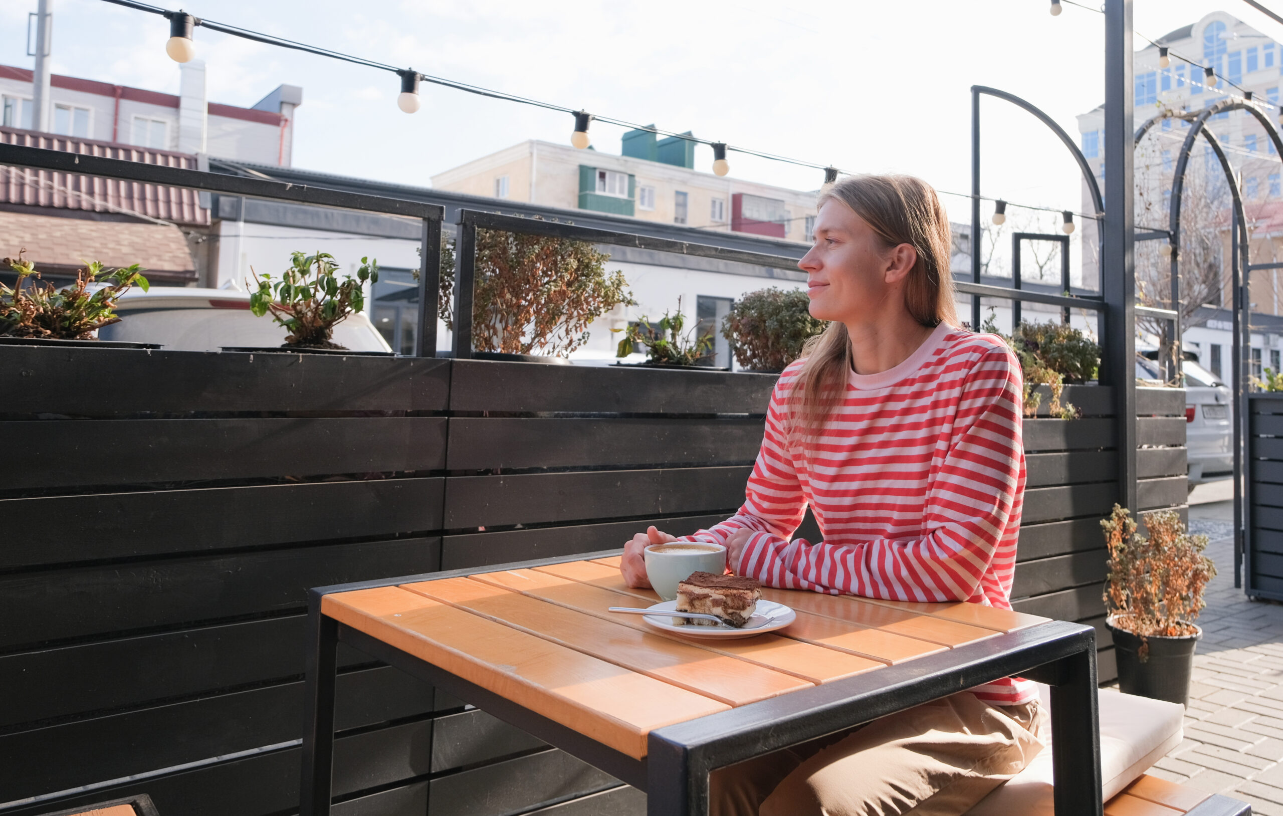 Things to do in Brighton on your own: Young Woman Sitting At A Street Cafe 