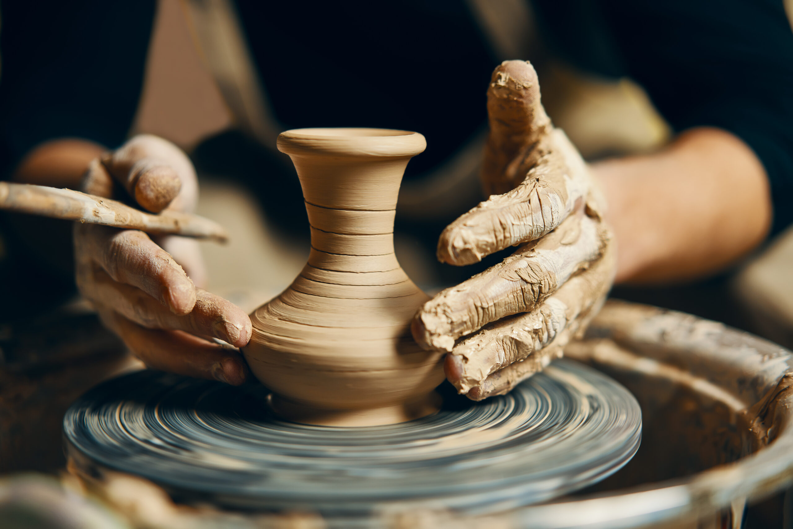 Hands Shaping Clay On A Pottery Wheel 