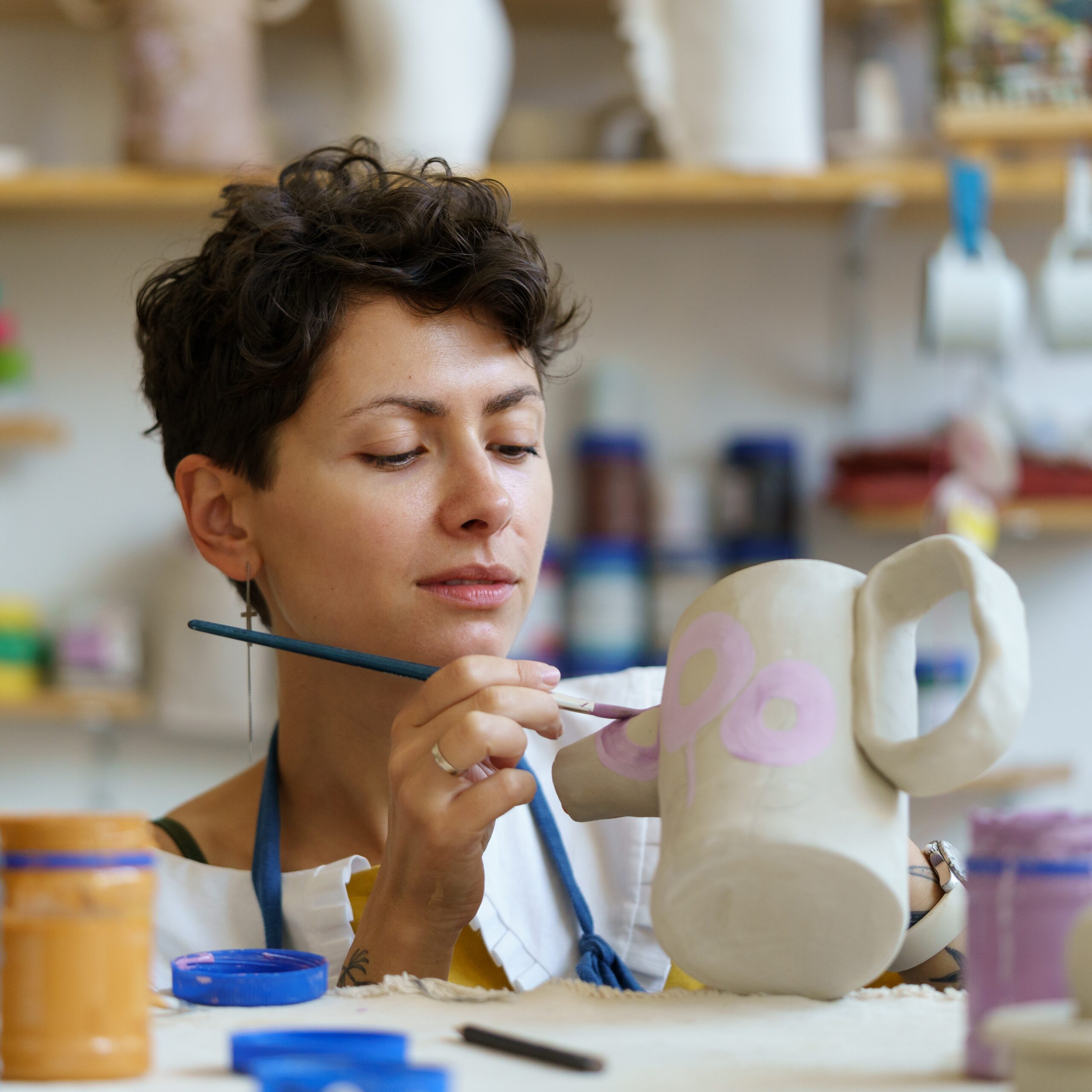 A woman doing pottery painting in Brighton