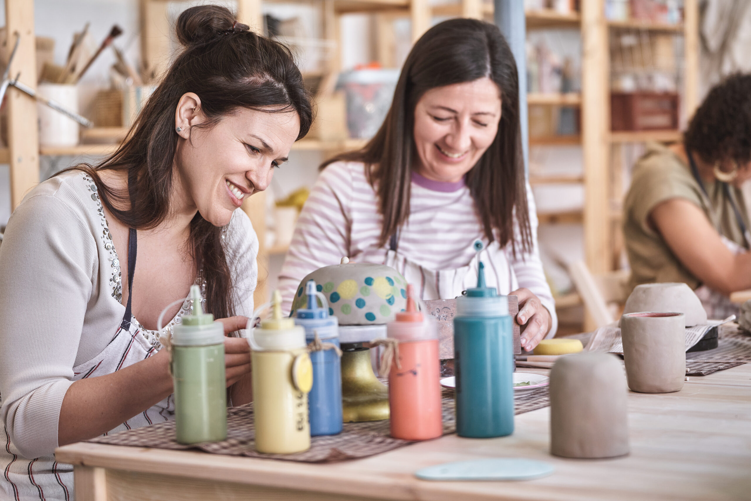 Two women doing pottery painting in Brighton