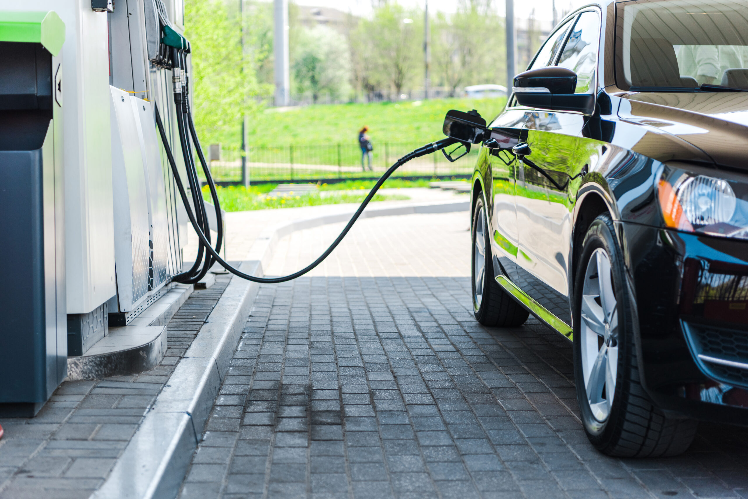 black modern car refuelling with benzine on gas station
