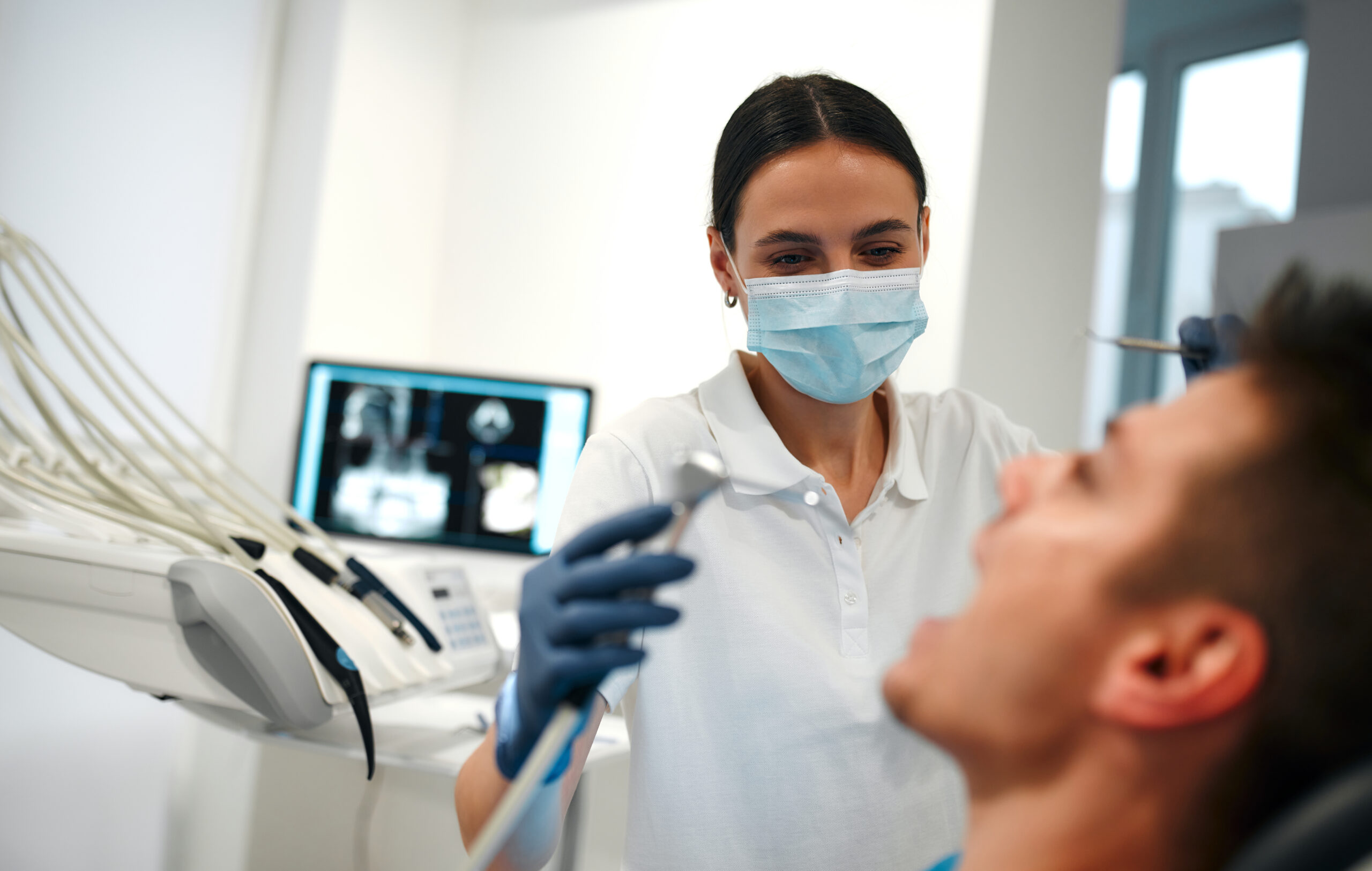 Dentist Working on Male Patient in Clinic
