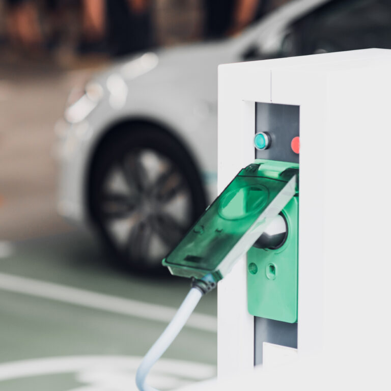 Electric Vehicle Charging Station with Car in Background