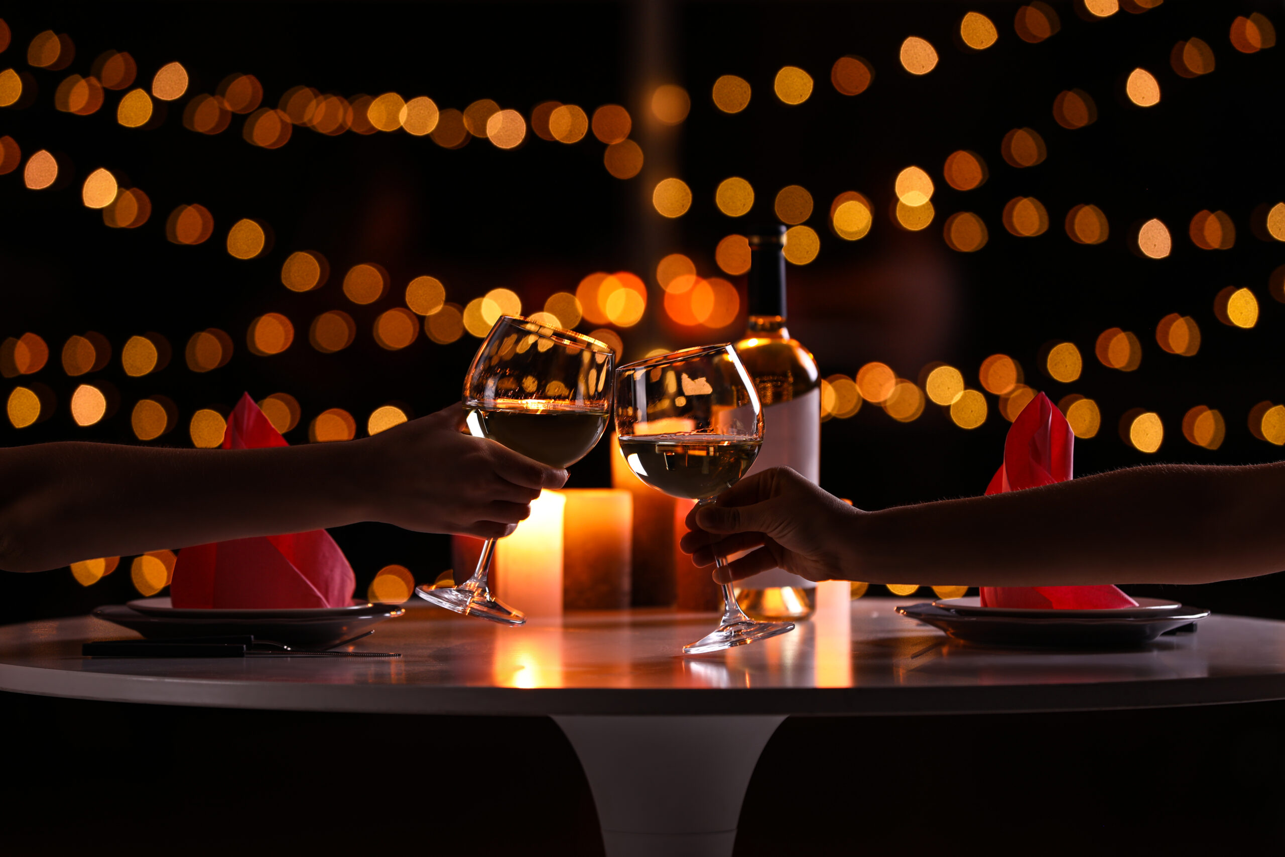 Romantic Wine Toast With Atmospheric Warm Lighting at one of the Brighton Marina restaurants