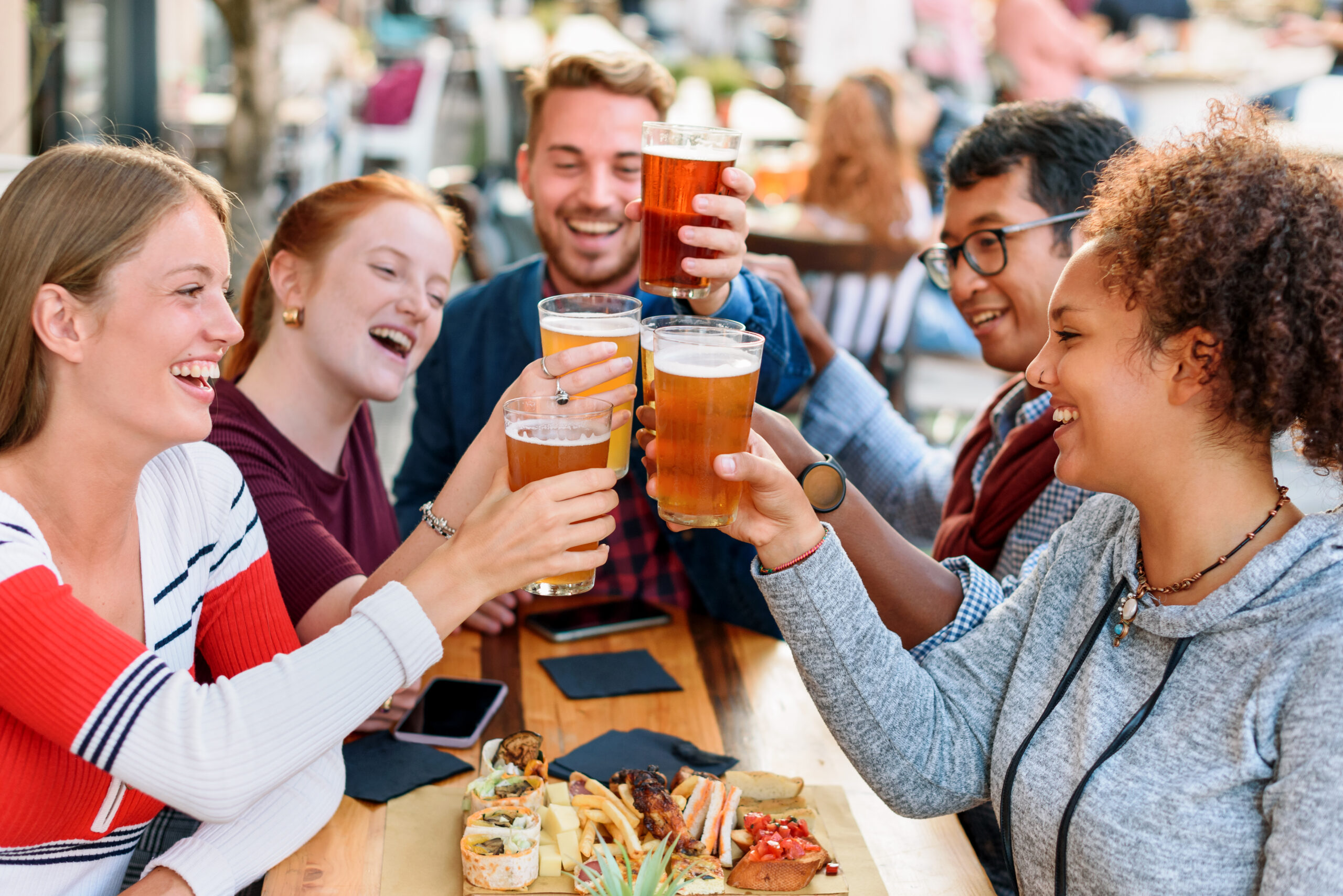 Smiling Friends Toasting Drinks in one of the best beer gardens in Brighton 