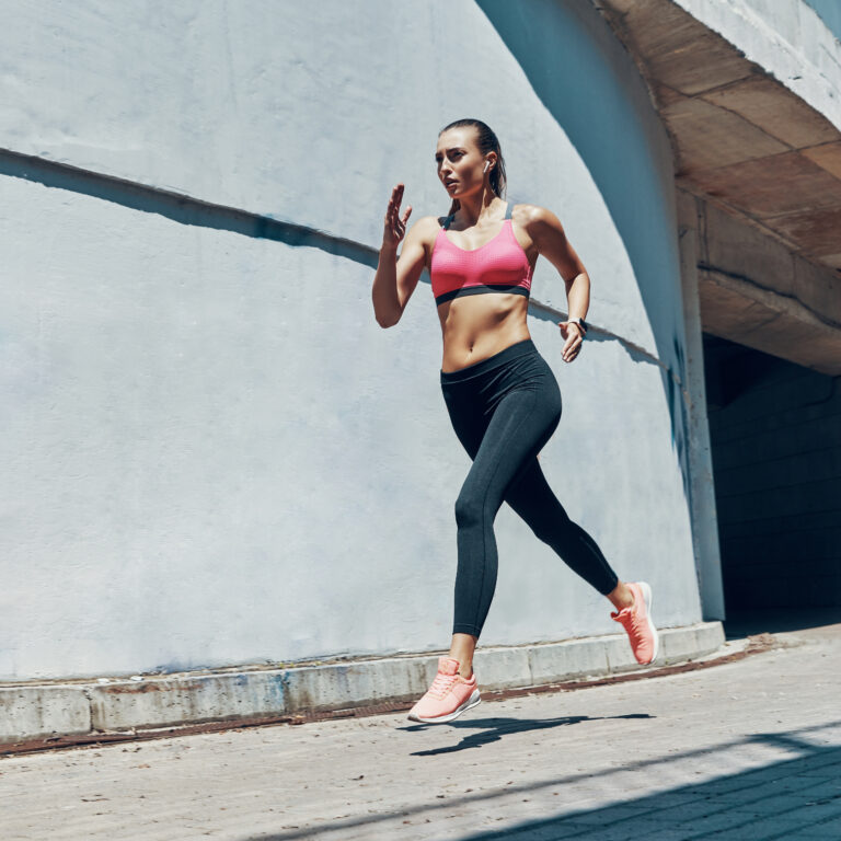 Athletic Woman Running In one of the running routes in Brighton