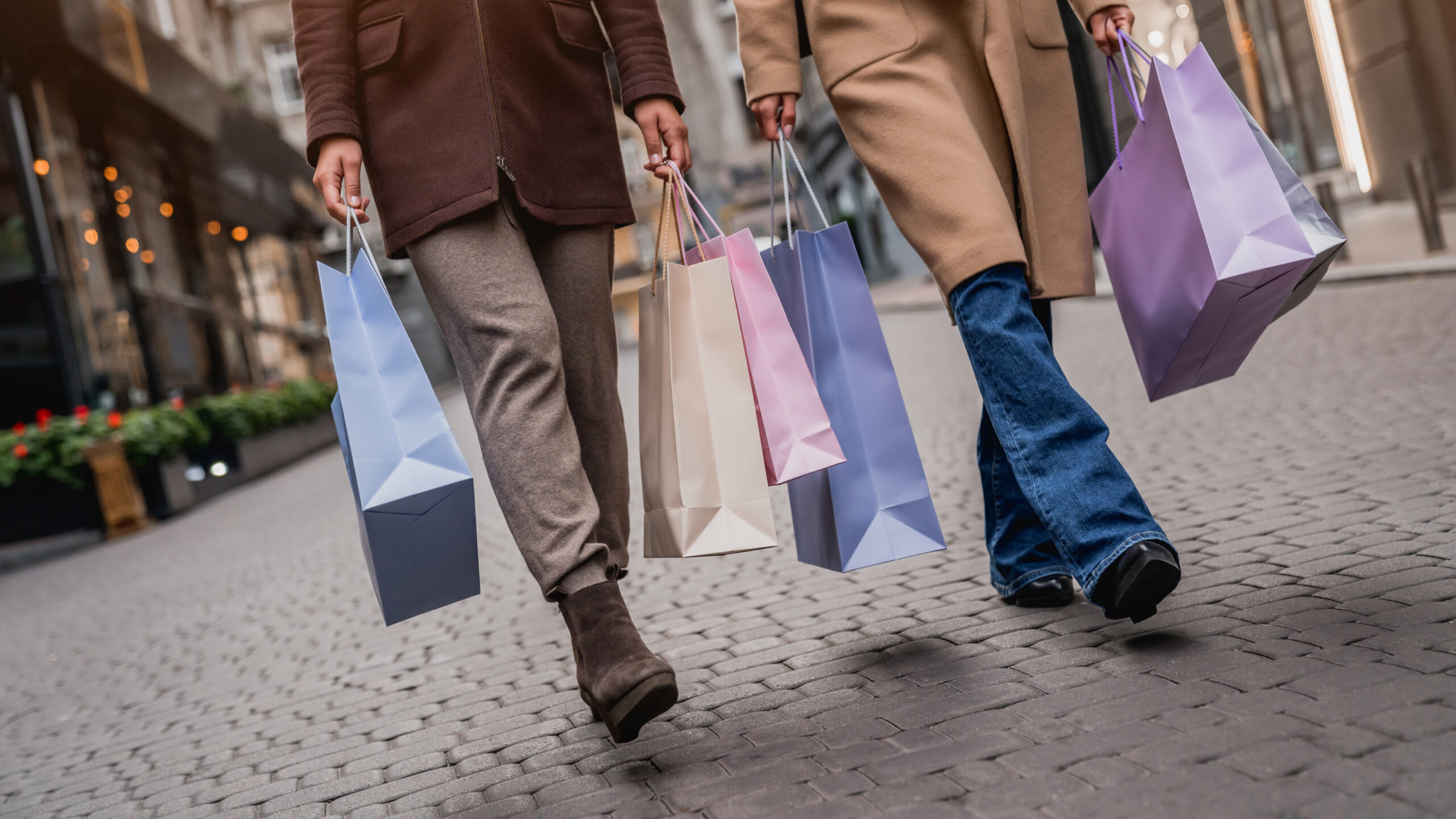 Cropped Front View Of Young Man and Woman With Shopping Bags 