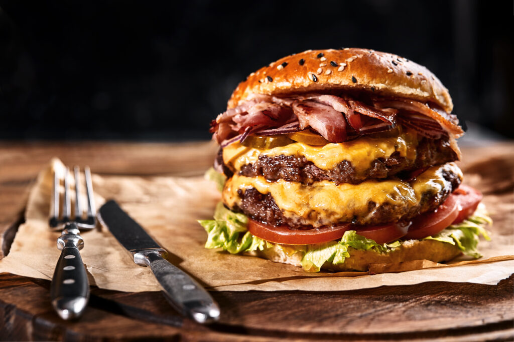 Fresh and juicy hamburger on a wooden table.