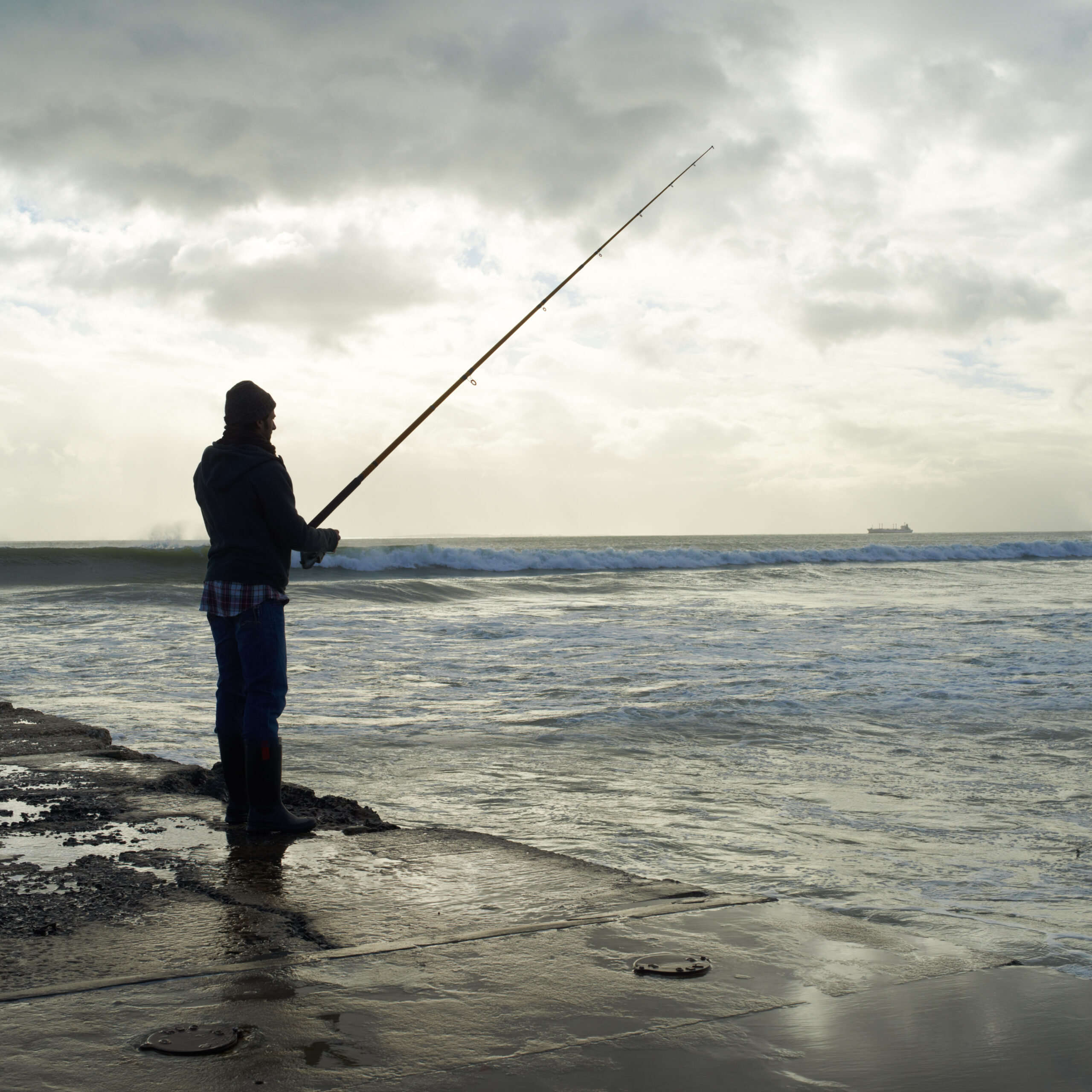 A man fishing in Brighton