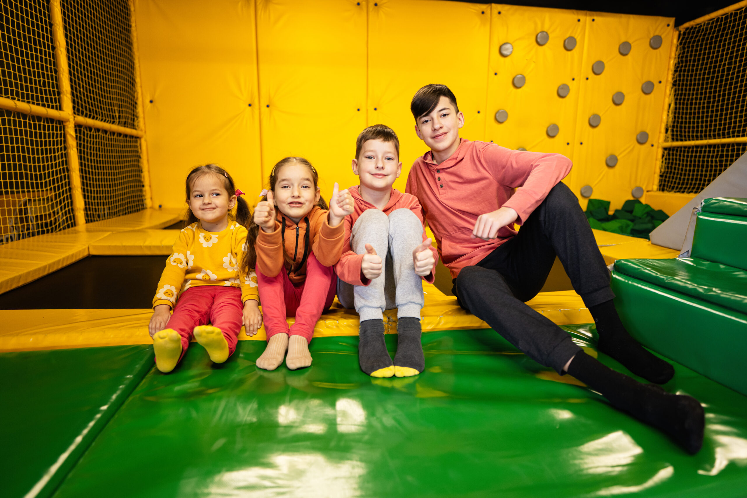 Four Kids Together Sit At Playground Park