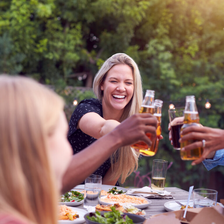 Friends Making Toast With Alcohol In a Garden