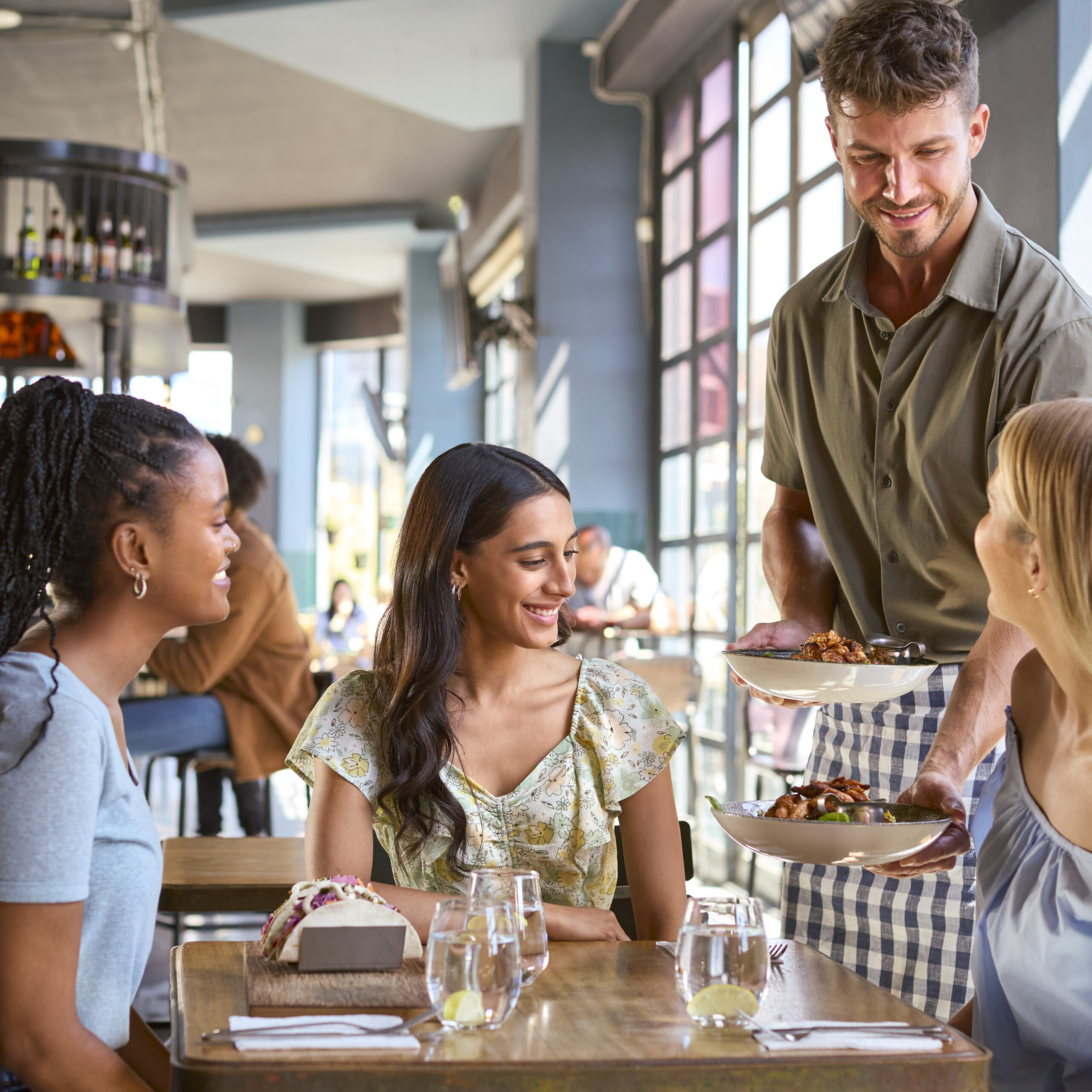Group Of Female Friends Meeting Up In a Restaurant