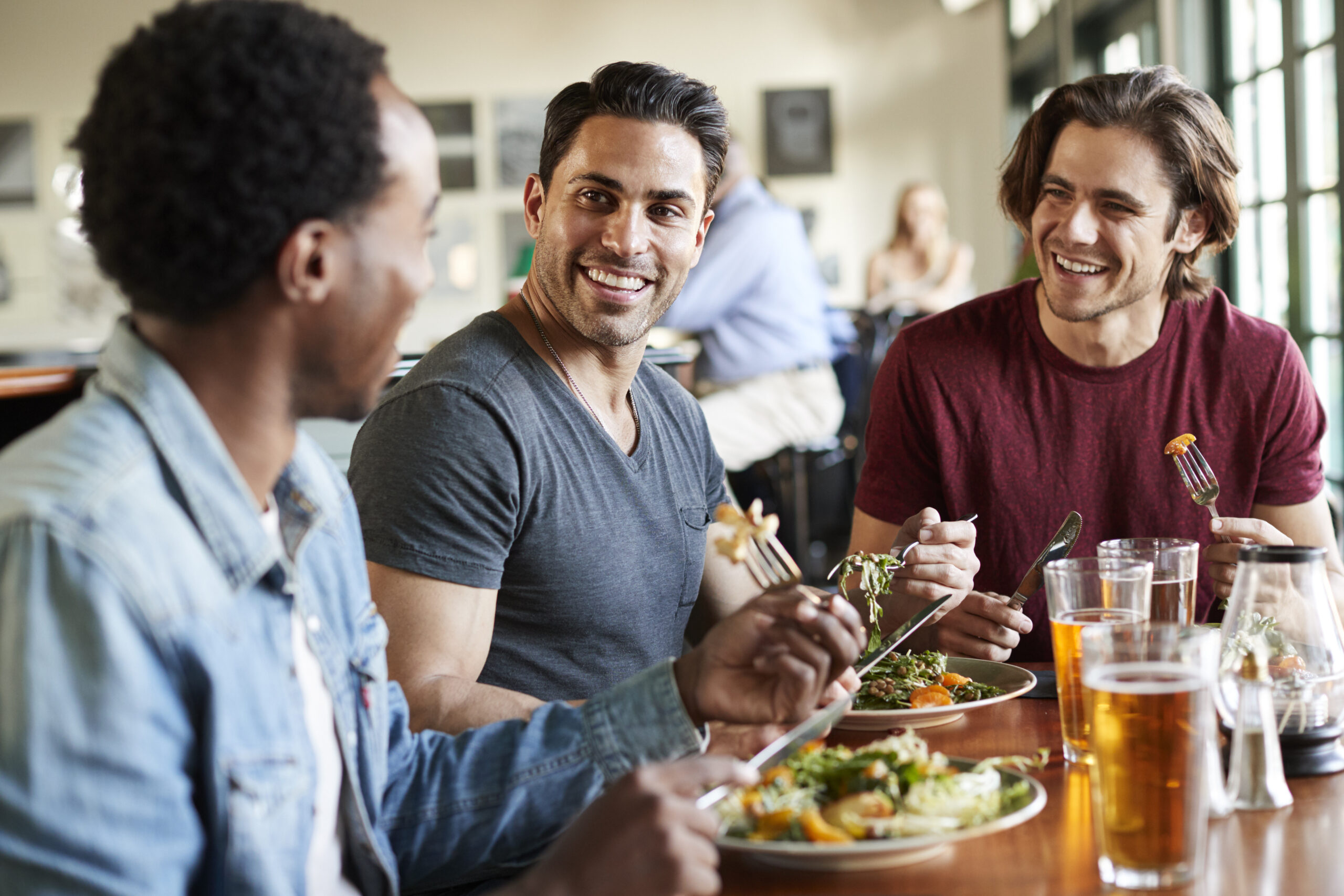 Group Of Male Friends Enjoying a Meal In a Restaurant 