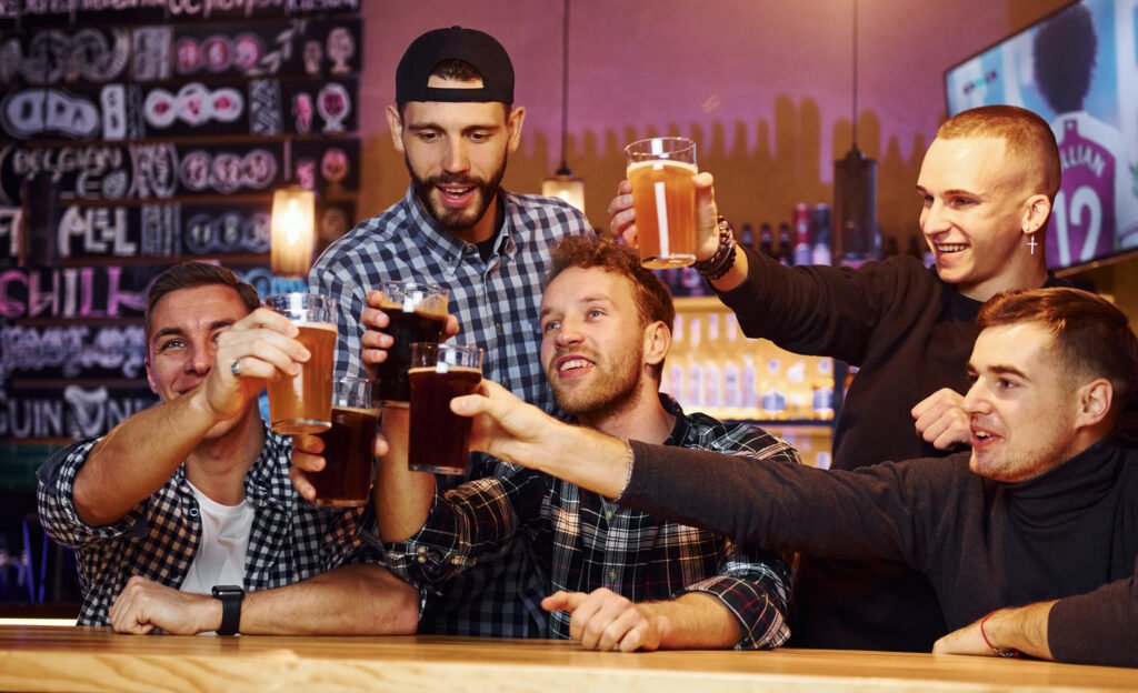 Group of people together indoors in the pub have fun at weekend time.