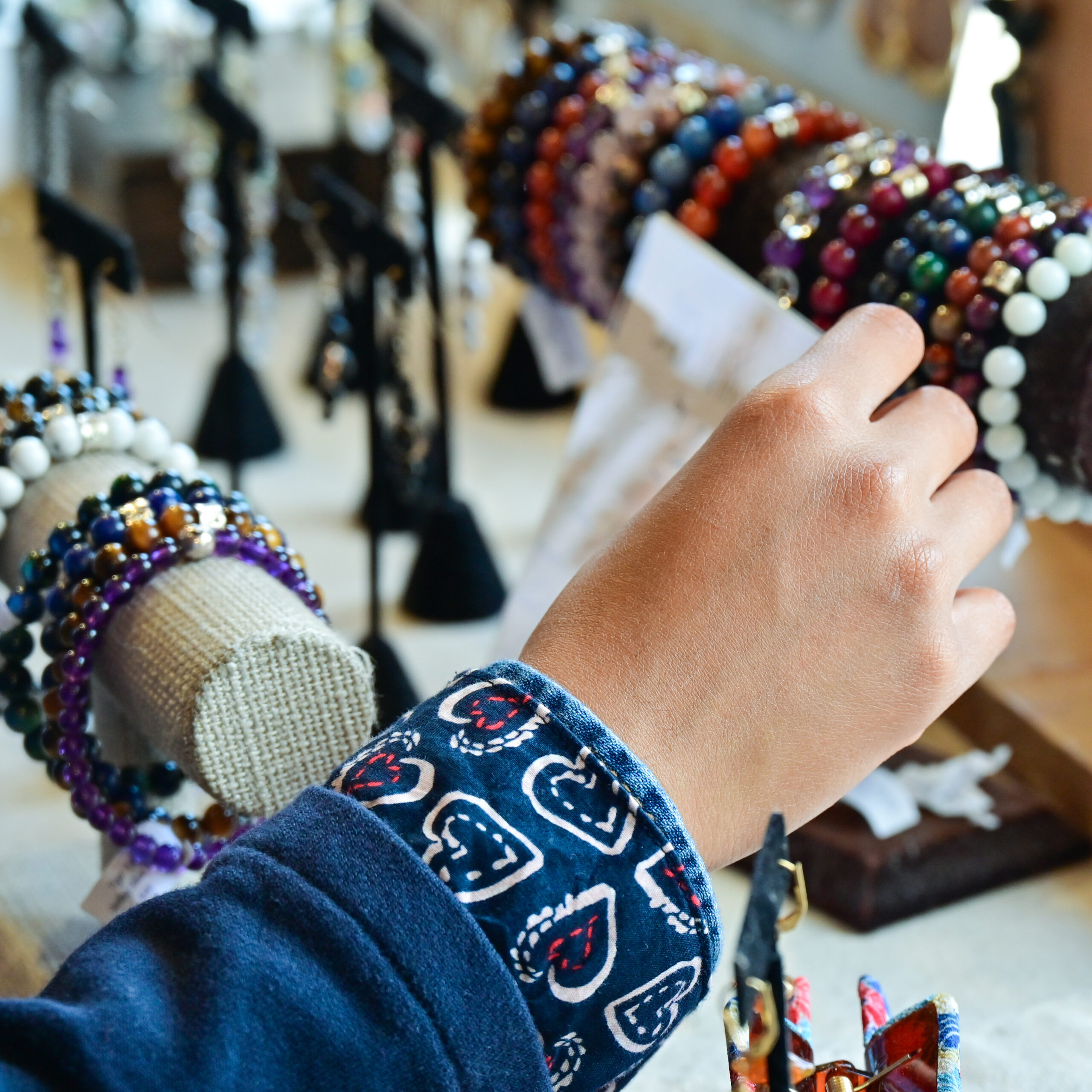 Hand Reaching For Beaded Bracelets At one of the Markets in Brighton