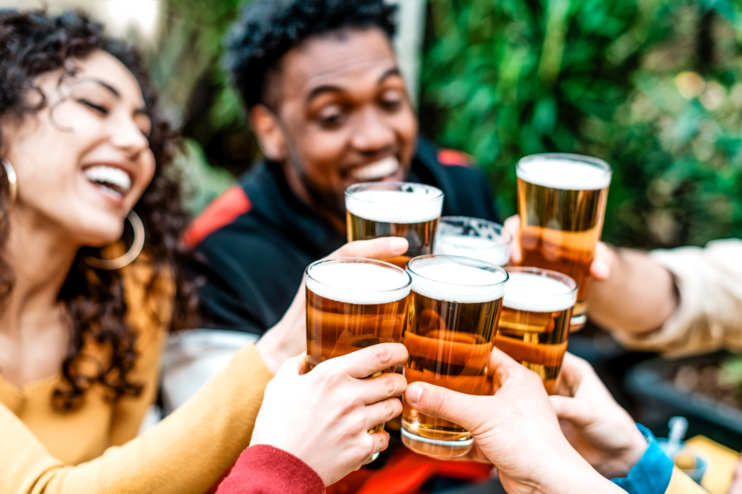 Happy Friends Toasting And Drinking Beer