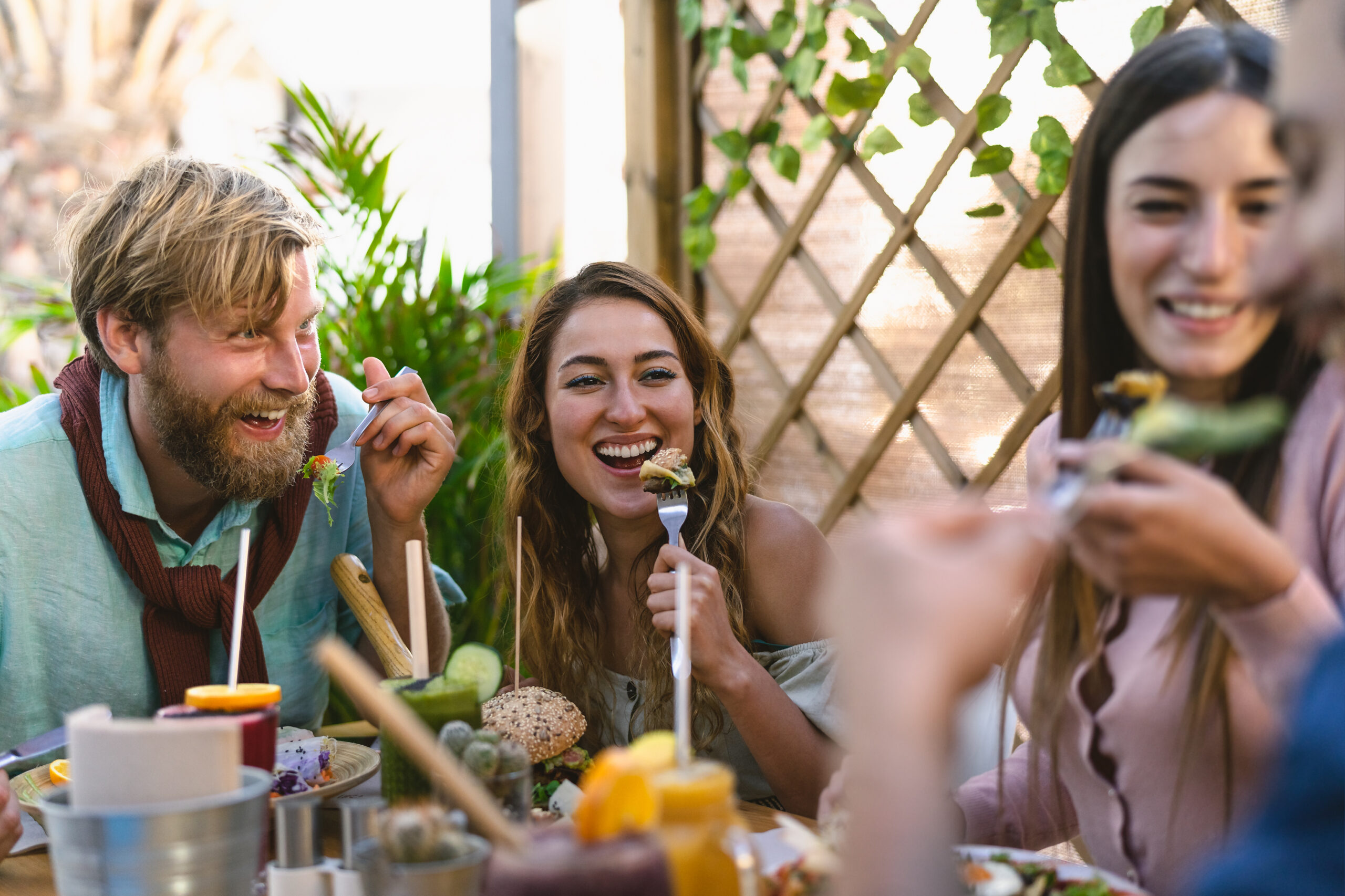 Happy Friends Lunching With Healthy Food In a Bar 
