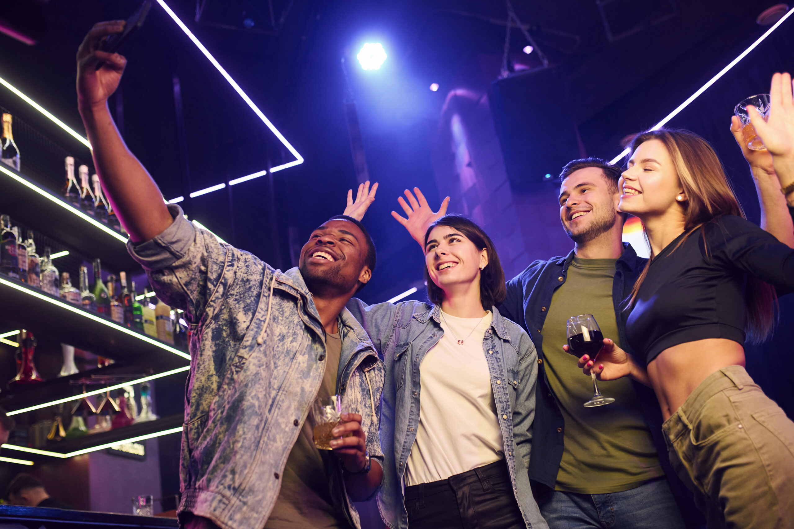 Birthday ideas in Brighton: Group of friends having fun in the night club together.