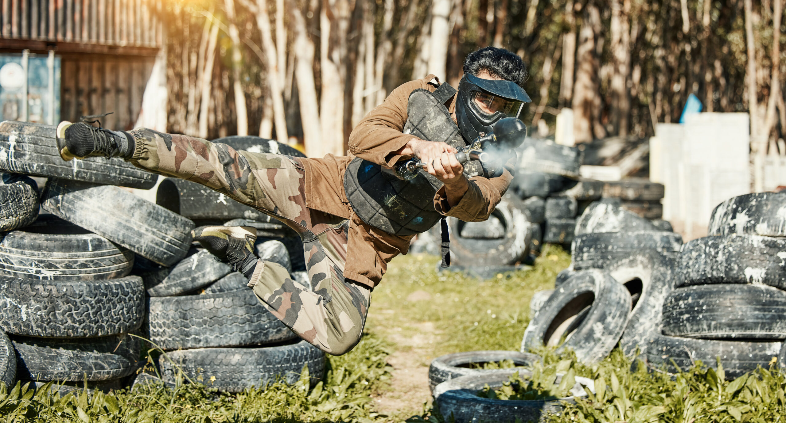 Man in Protective Gear Playing Intense Paintball Game
