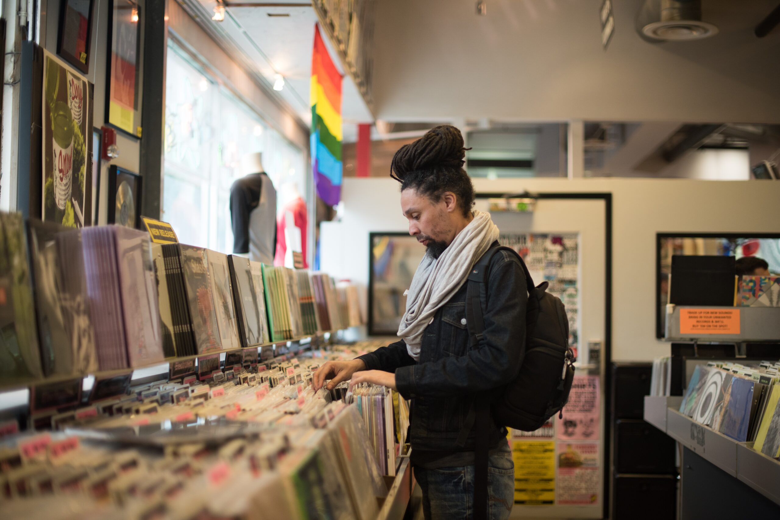 Man Searching Through Vinyl Records In a Music Store