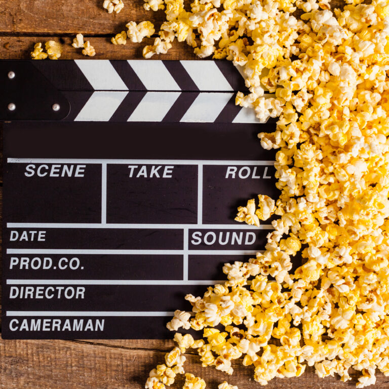 Movie Clapperboard Surrounded by Delicious Yellow Popcorn