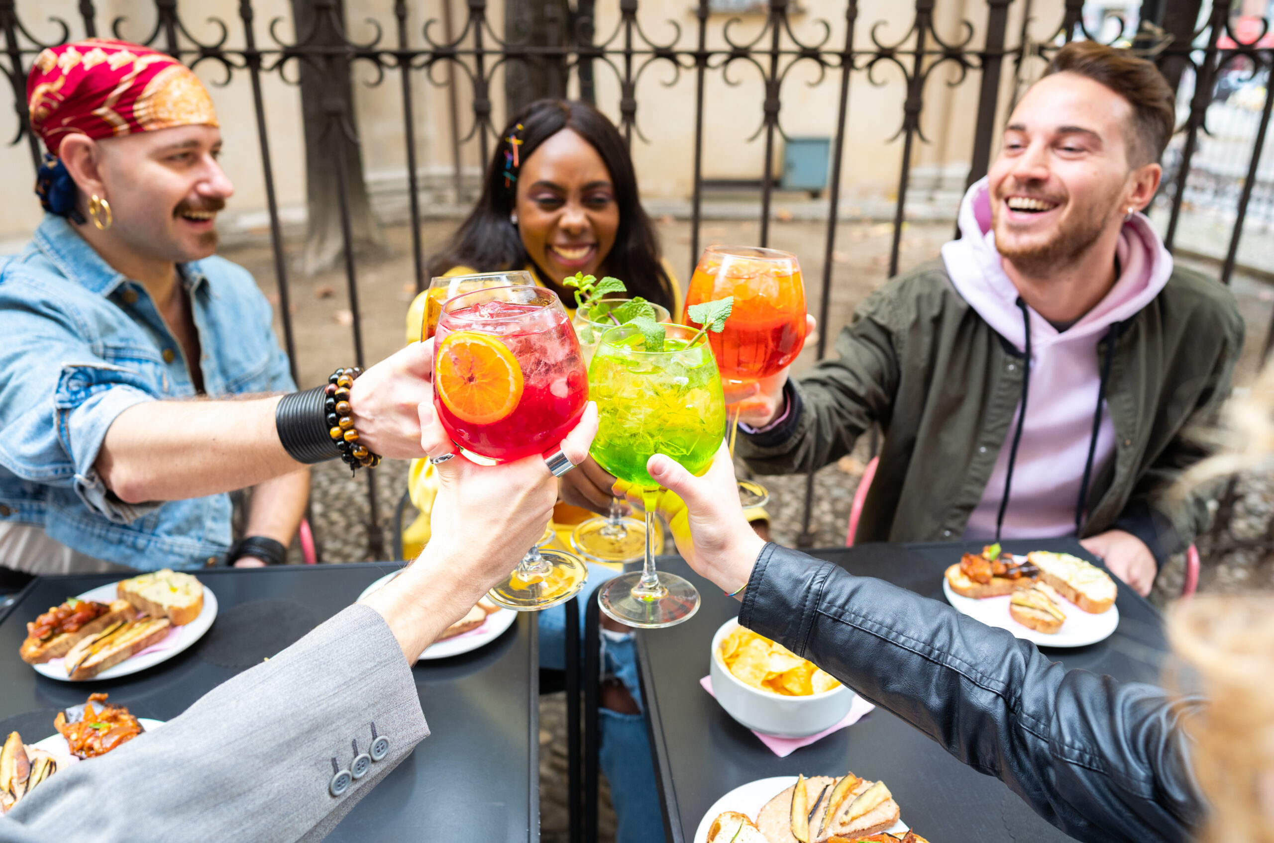 Friends Toasting With Coloured Cocktails
