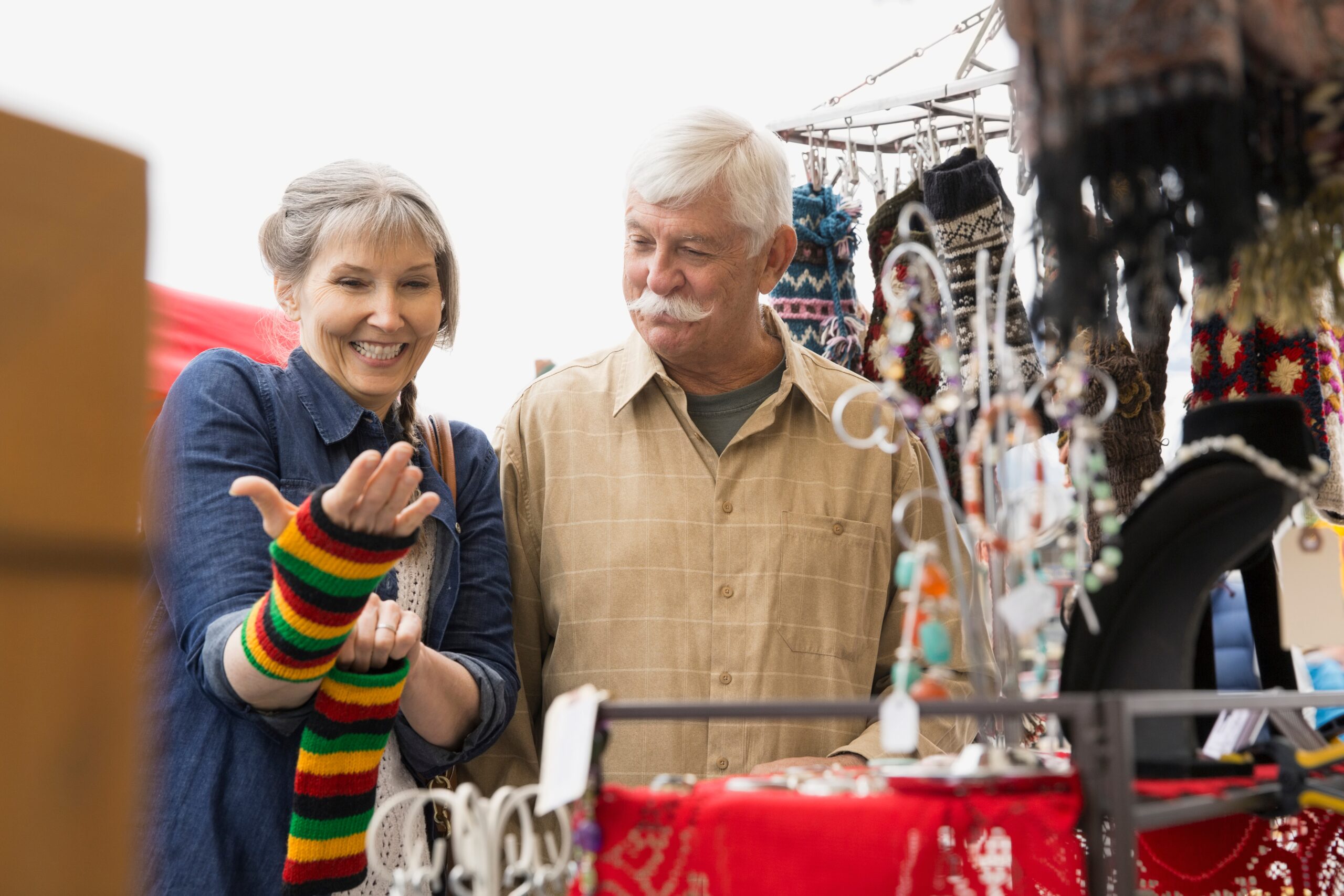 Older Couple Shopping At Outdoor Market
